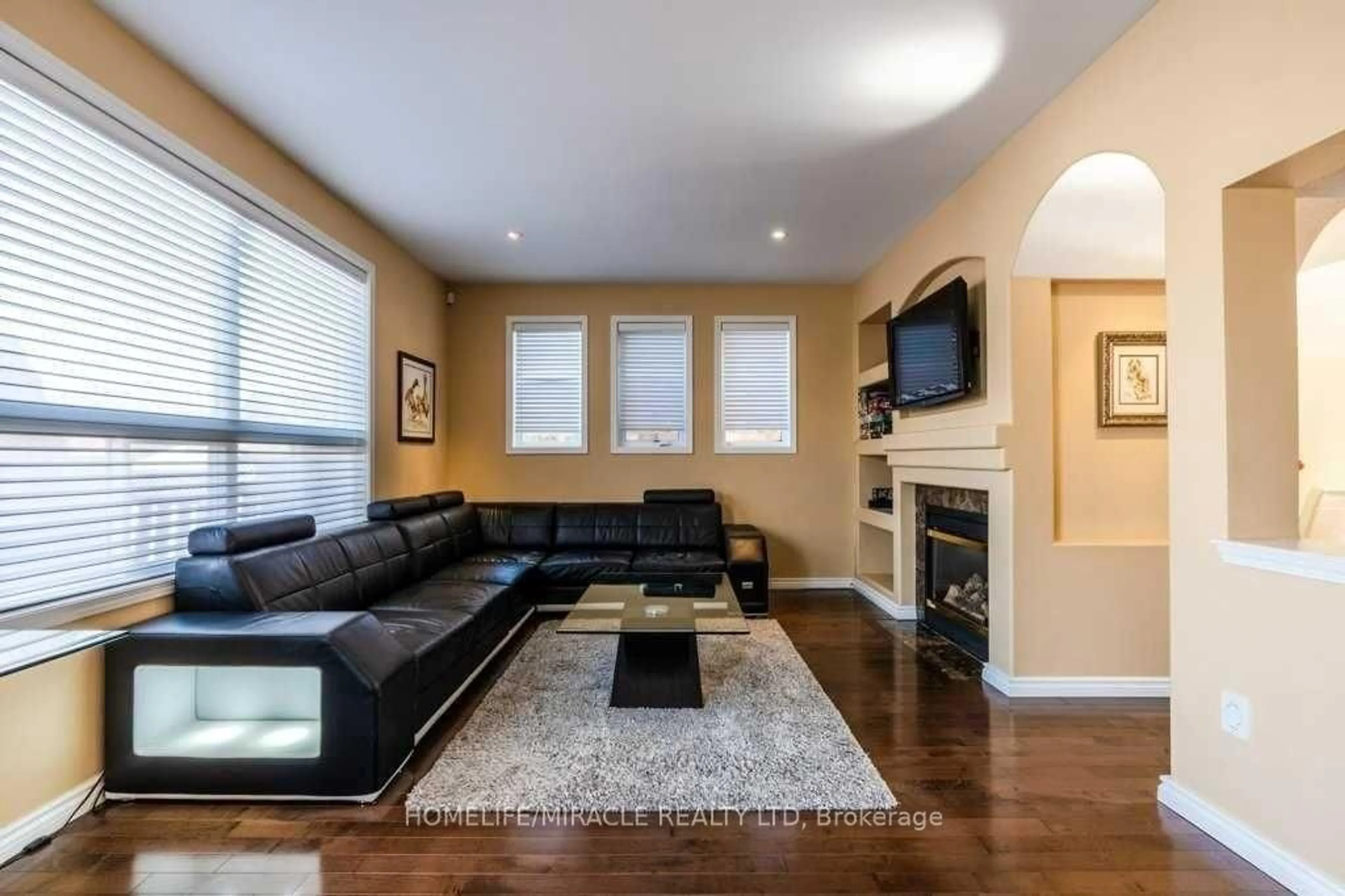 Living room with furniture, wood/laminate floor for 5 Leagrove St, Brampton Ontario L7A 1P2