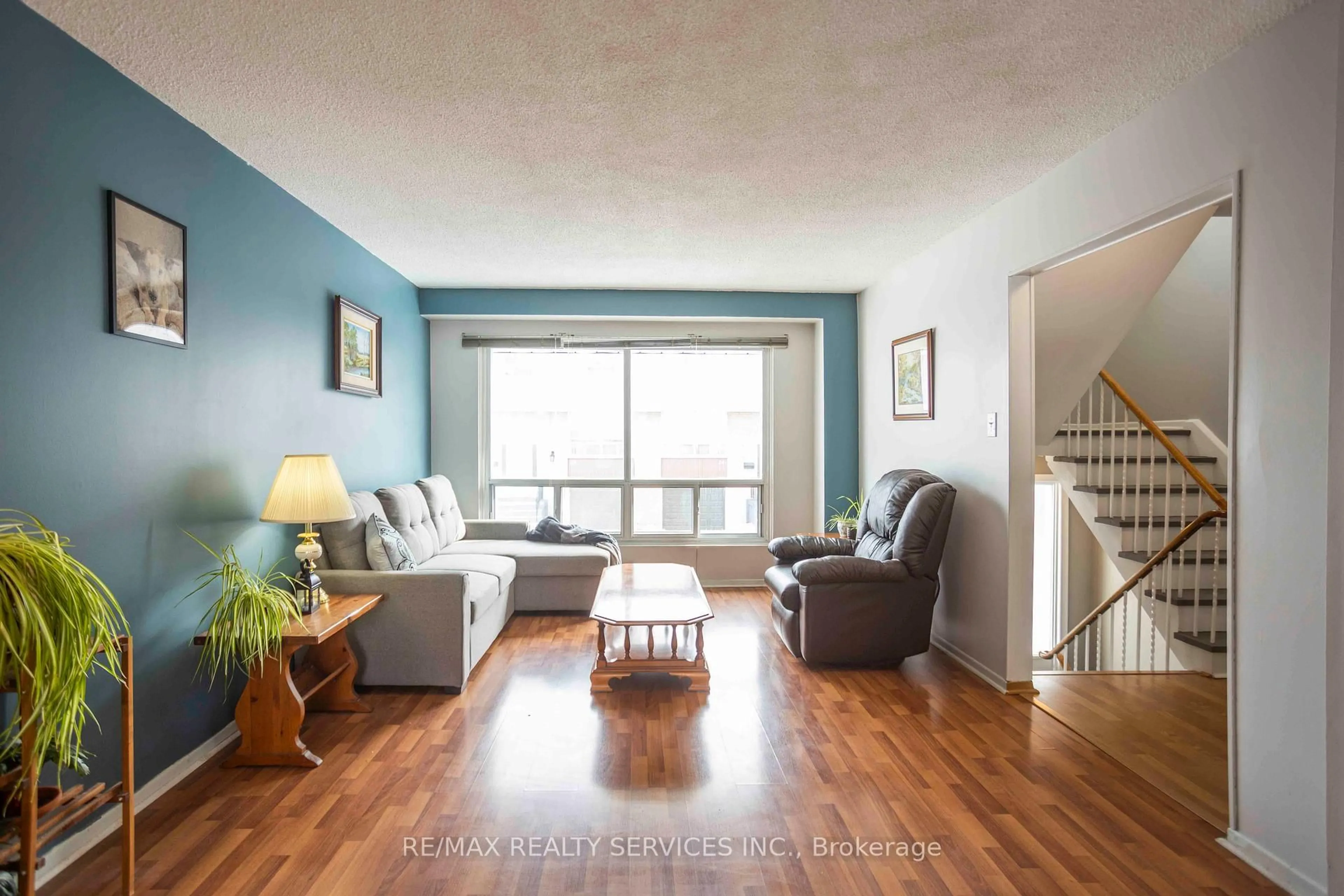 Living room with furniture, wood/laminate floor for 806 Stainton Dr #6H, Mississauga Ontario L5C 2T2