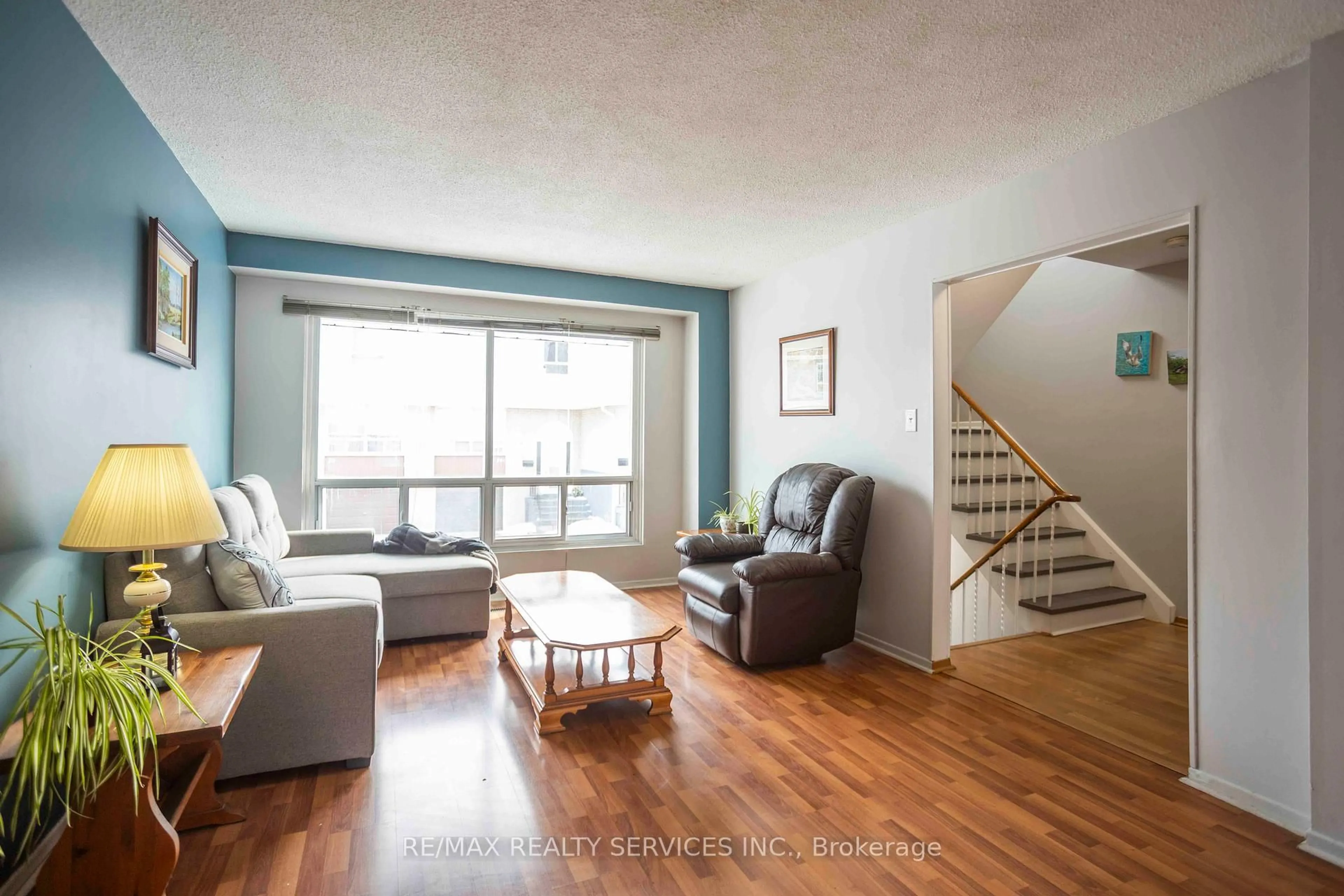 Living room with furniture, wood/laminate floor for 806 Stainton Dr #6H, Mississauga Ontario L5C 2T2