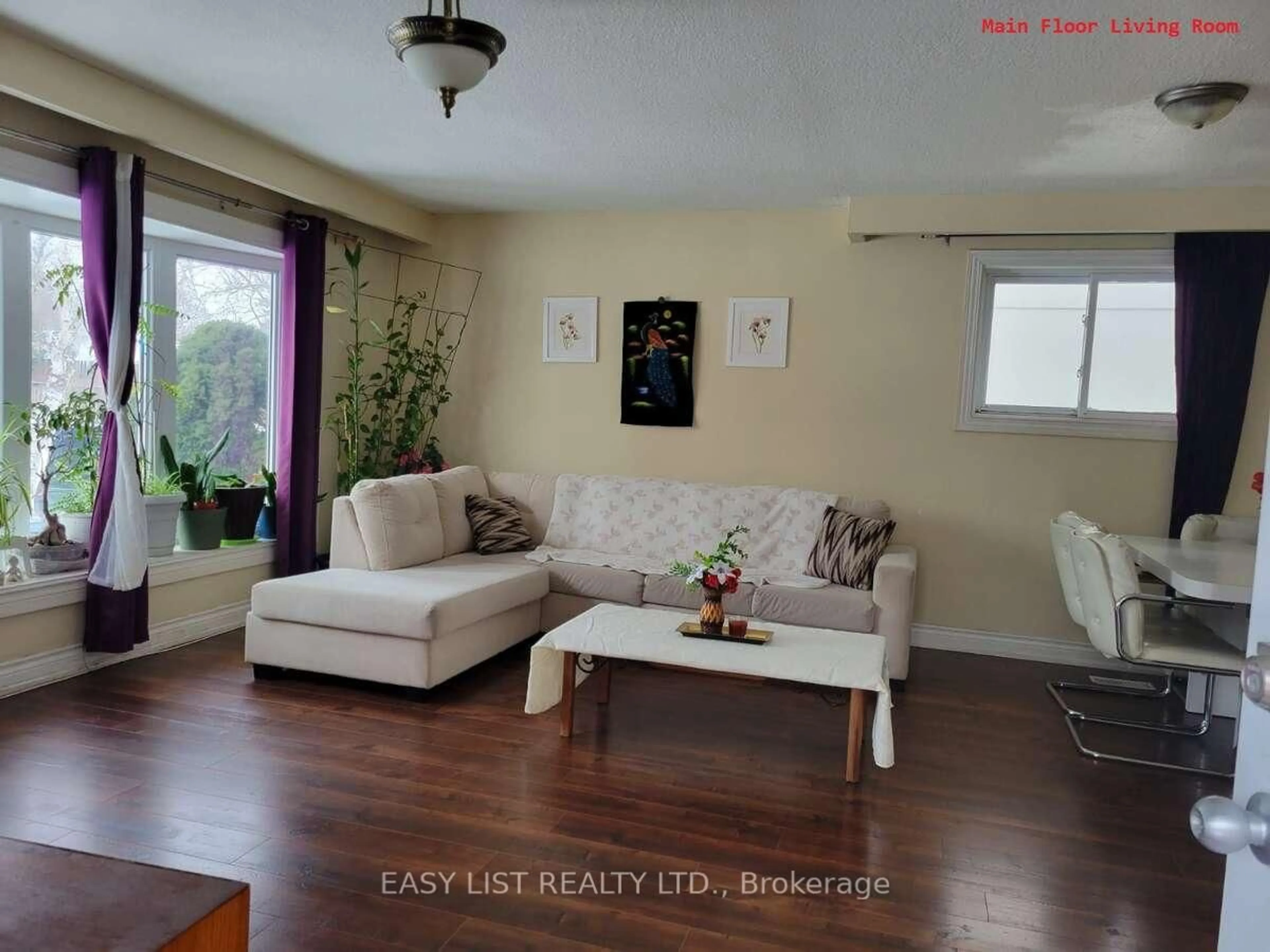 Living room with furniture, wood/laminate floor for 28 Cumbrian Crt, Brampton Ontario L6X 2J8