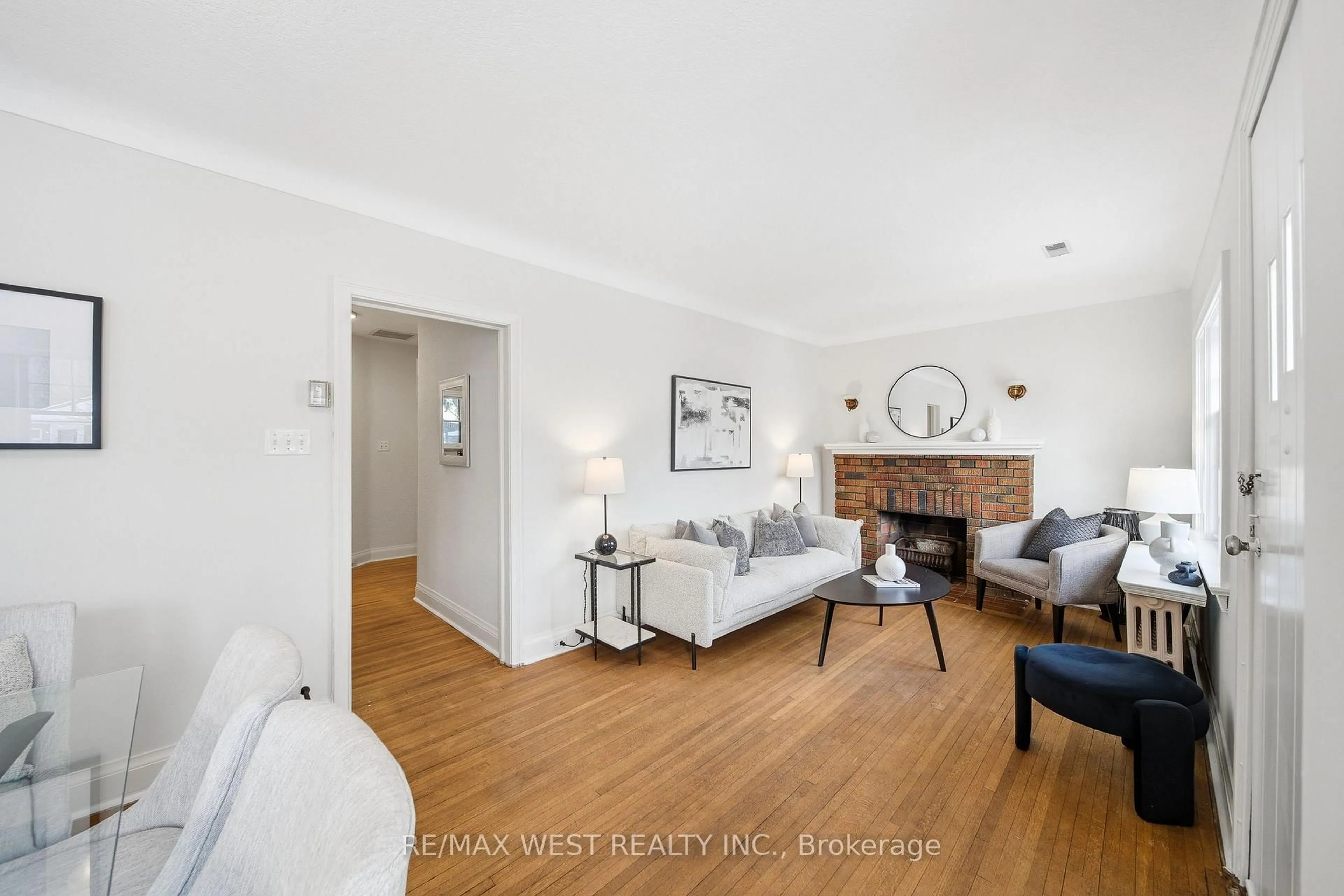Living room with furniture, wood/laminate floor for 66 South Kingsway, Toronto Ontario M6S 3T3