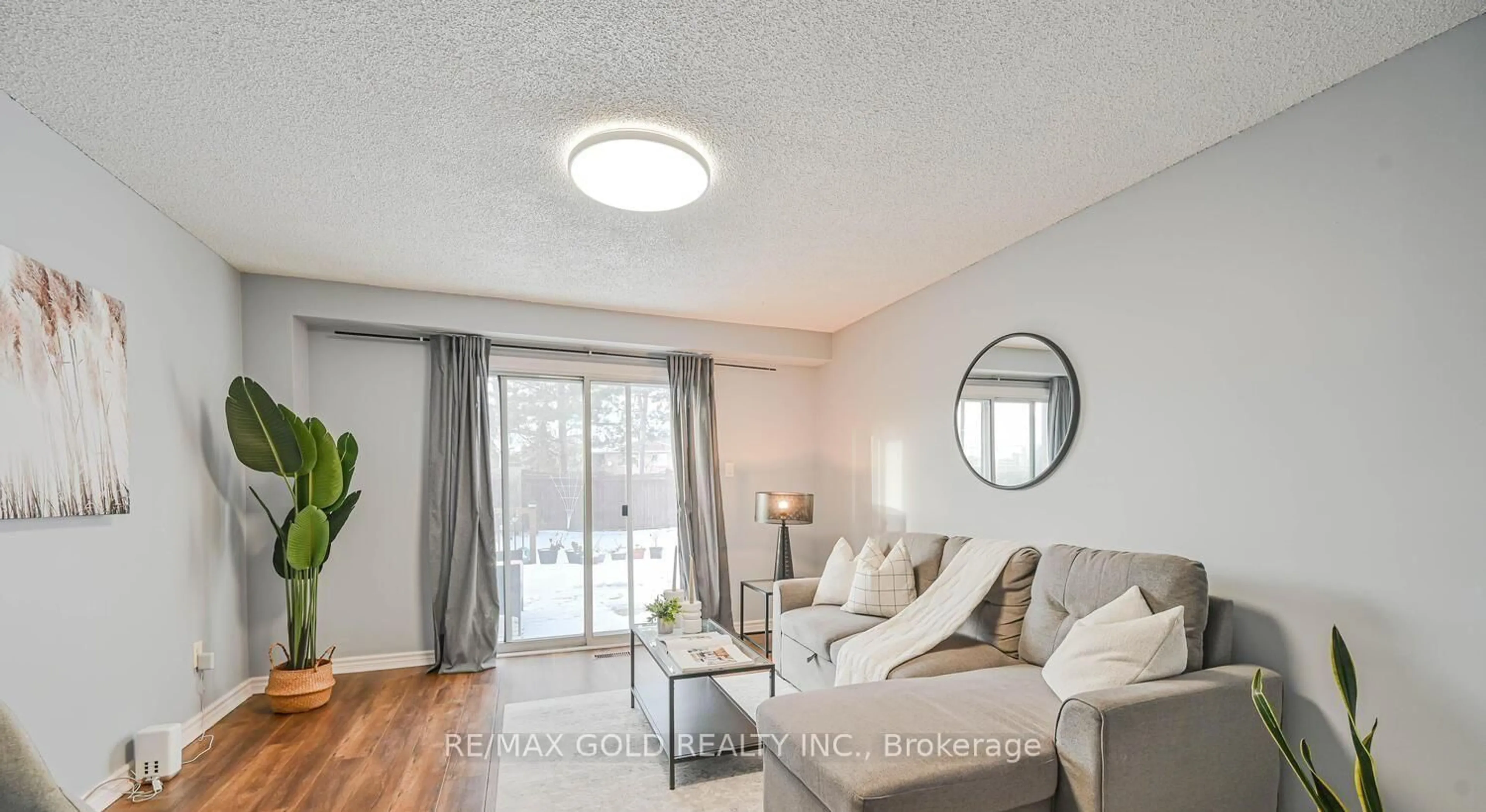 Living room with furniture, wood/laminate floor for 73 Chipmunk Cres, Brampton Ontario L6R 1B4