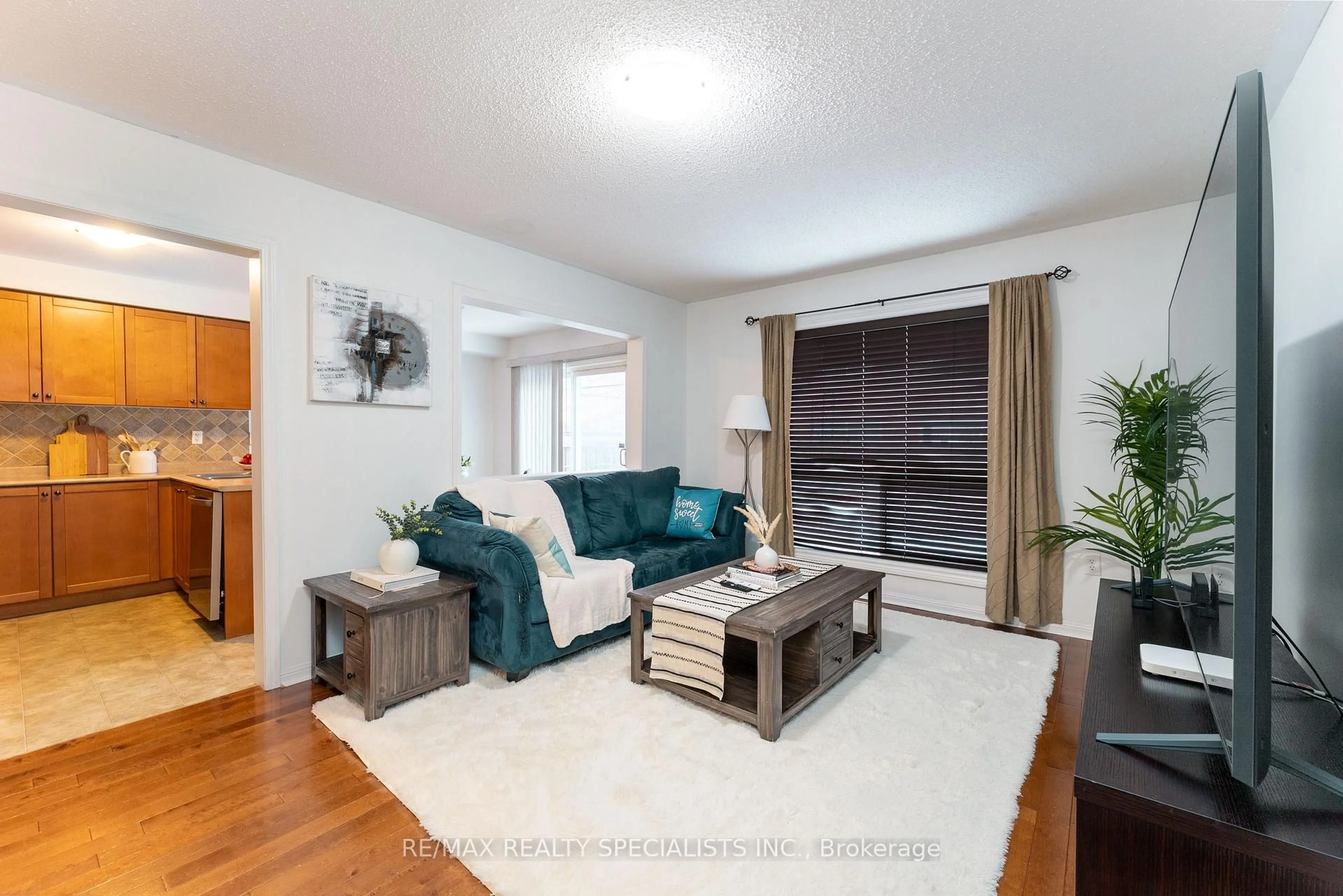 Living room with furniture, wood/laminate floor for 1134 Riddell Cres, Milton Ontario L9T 6Y2