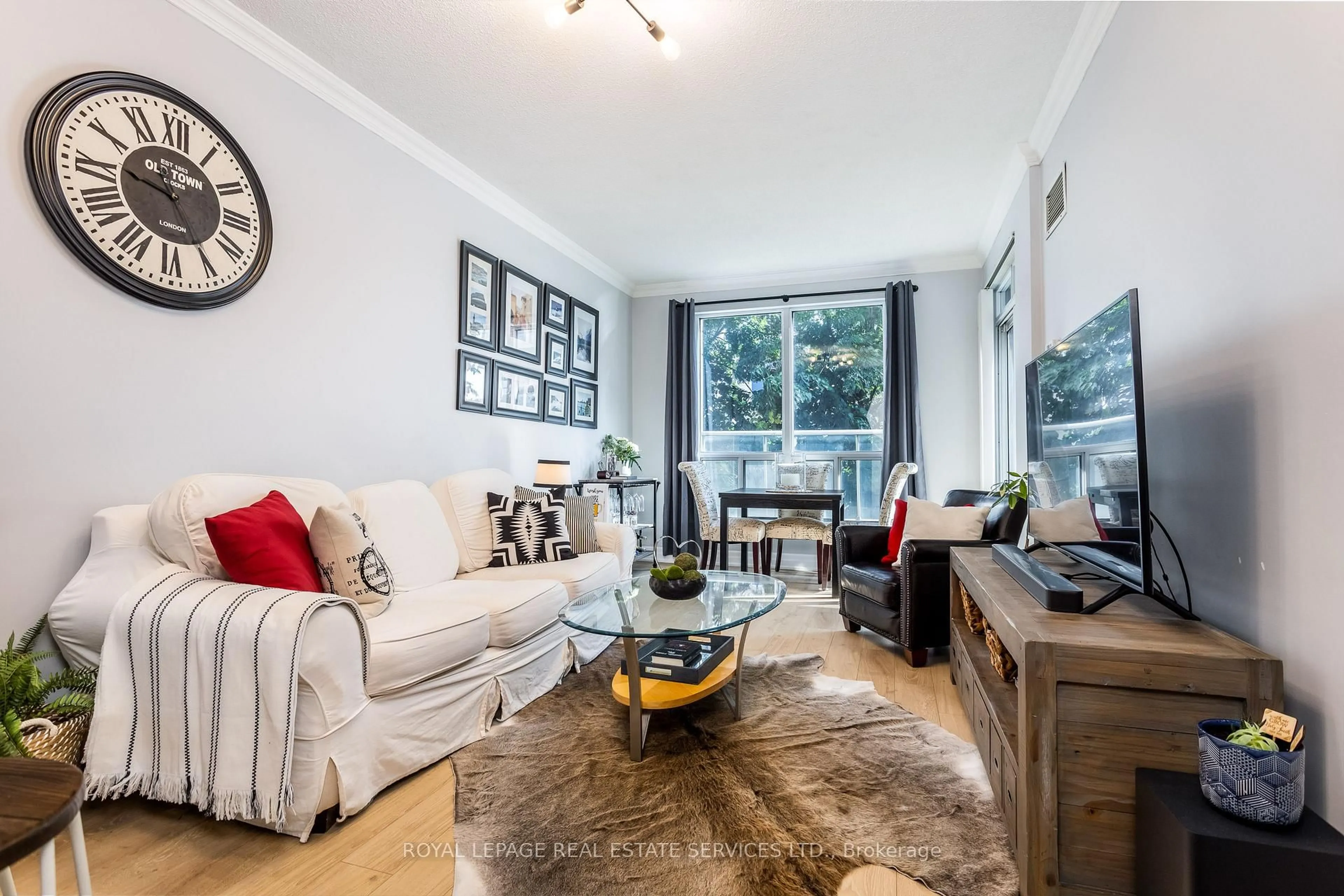 Living room with furniture, wood/laminate floor for 2083 Lake Shore Blvd #109, Toronto Ontario M8V 4G2