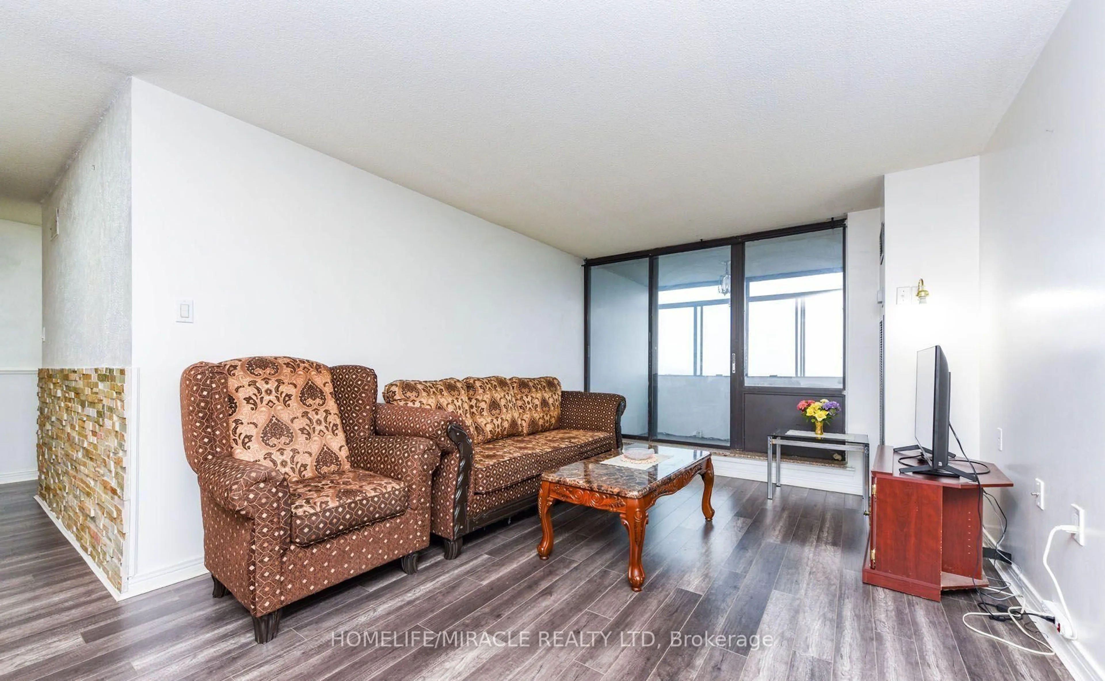 Living room with furniture, wood/laminate floor for 18 Knightsbridge Rd #2005, Brampton Ontario L6T 3X5