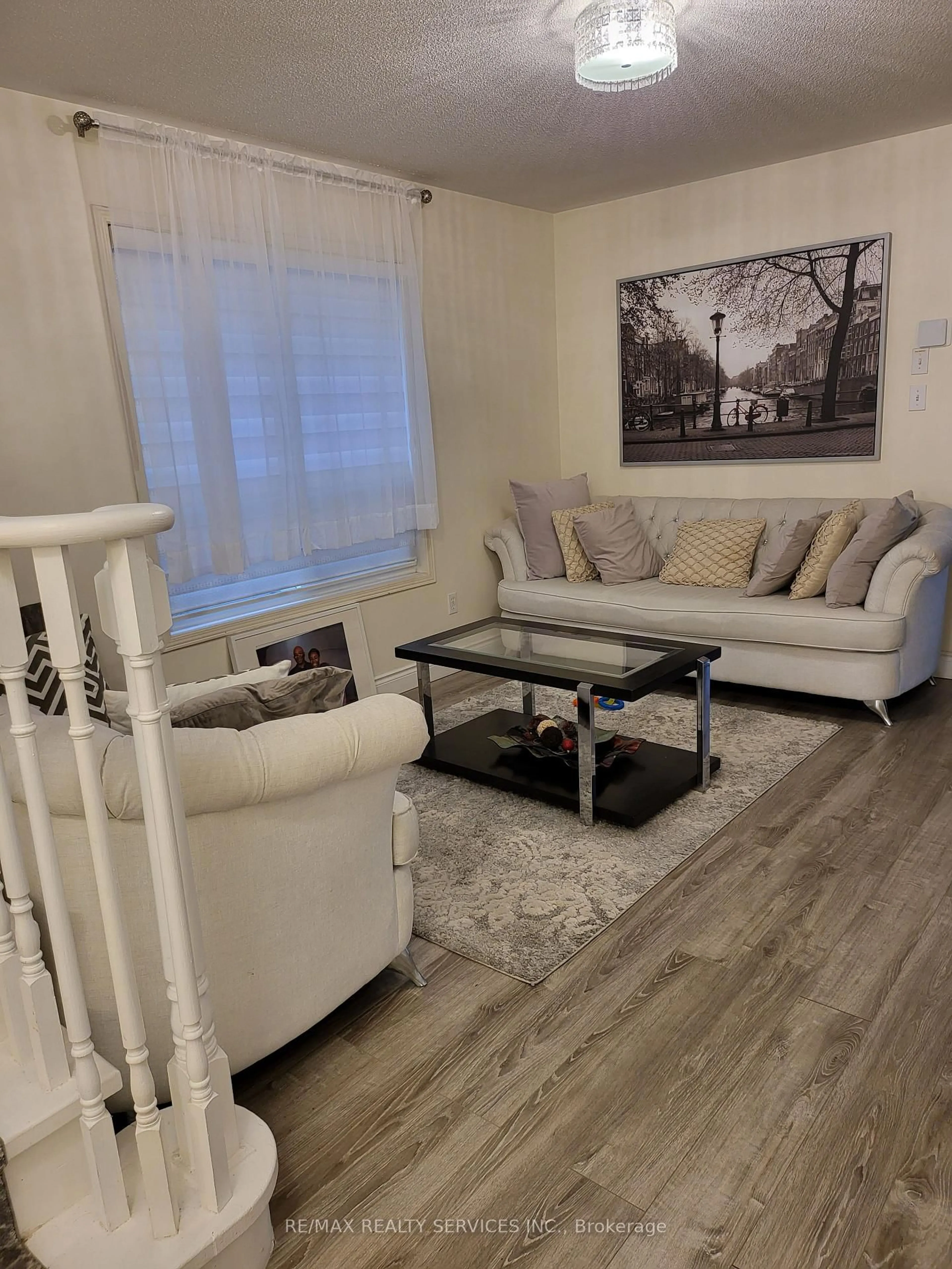 Living room with furniture, wood/laminate floor for 19 Albery Rd, Brampton Ontario L7A 0K7