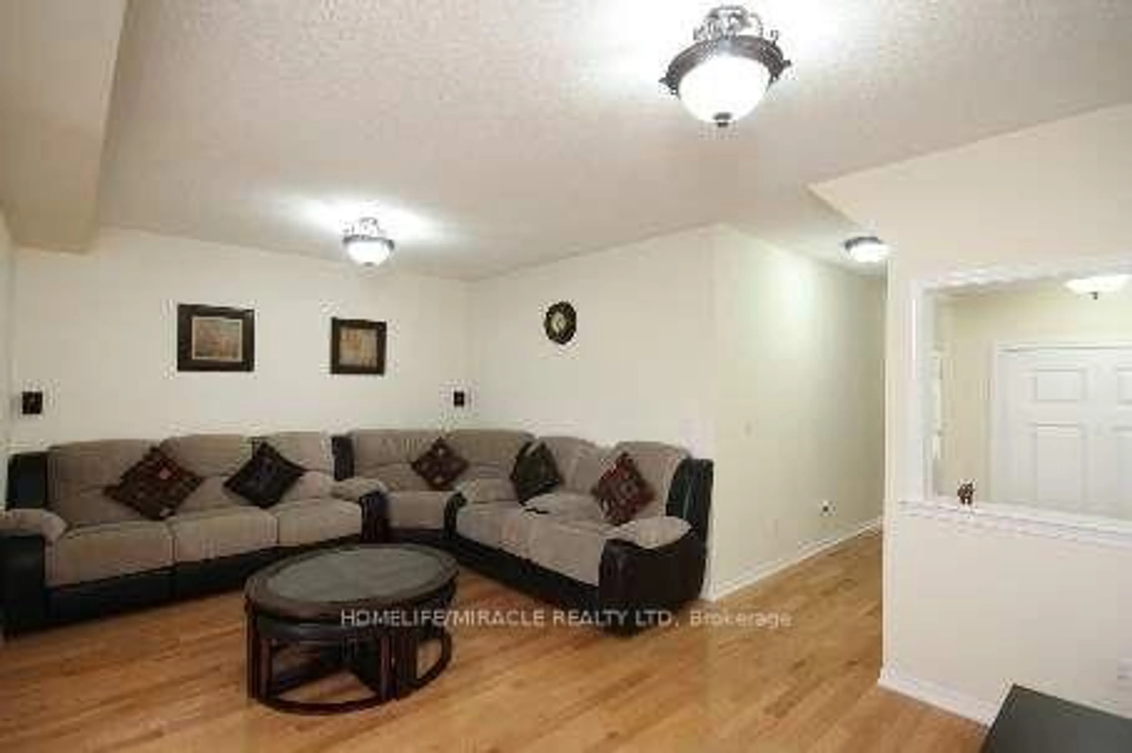 Living room with furniture, wood/laminate floor for 16 Unionville Cres, Brampton Ontario L6P 2Z4