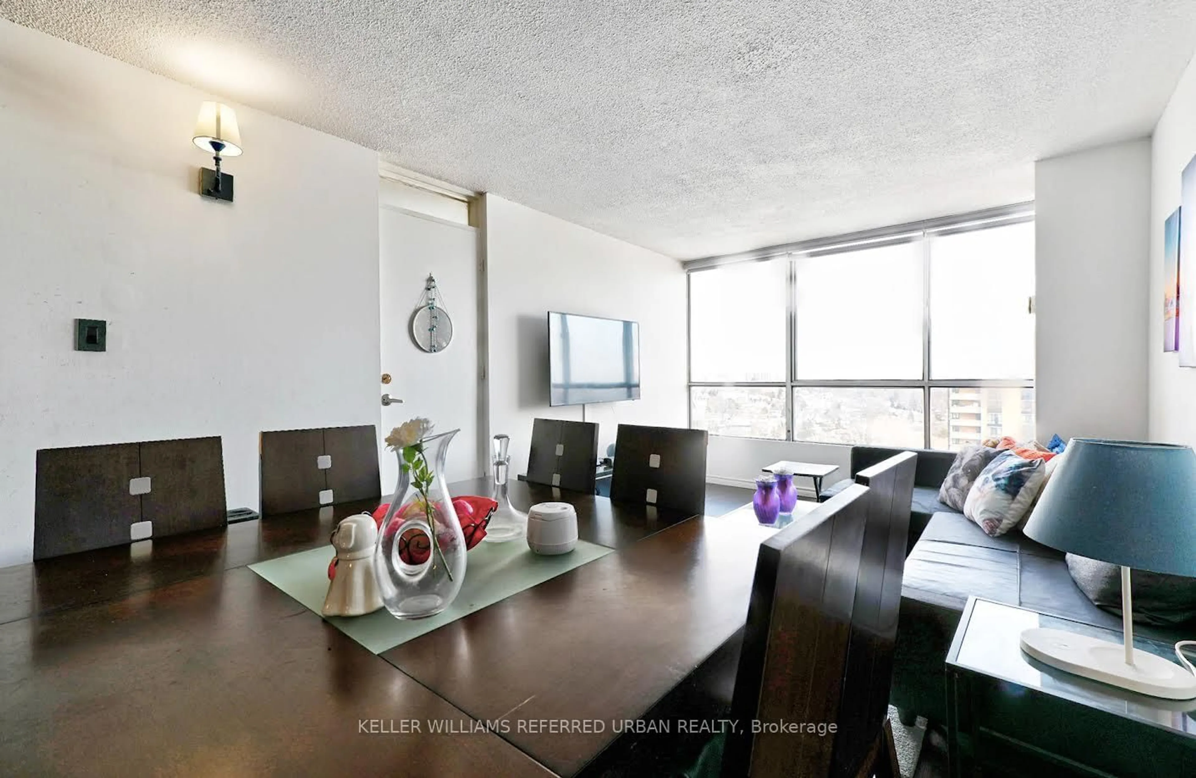 Living room with furniture, wood/laminate floor for 10 Martha Eaton Way #1811, Toronto Ontario M6M 5B3