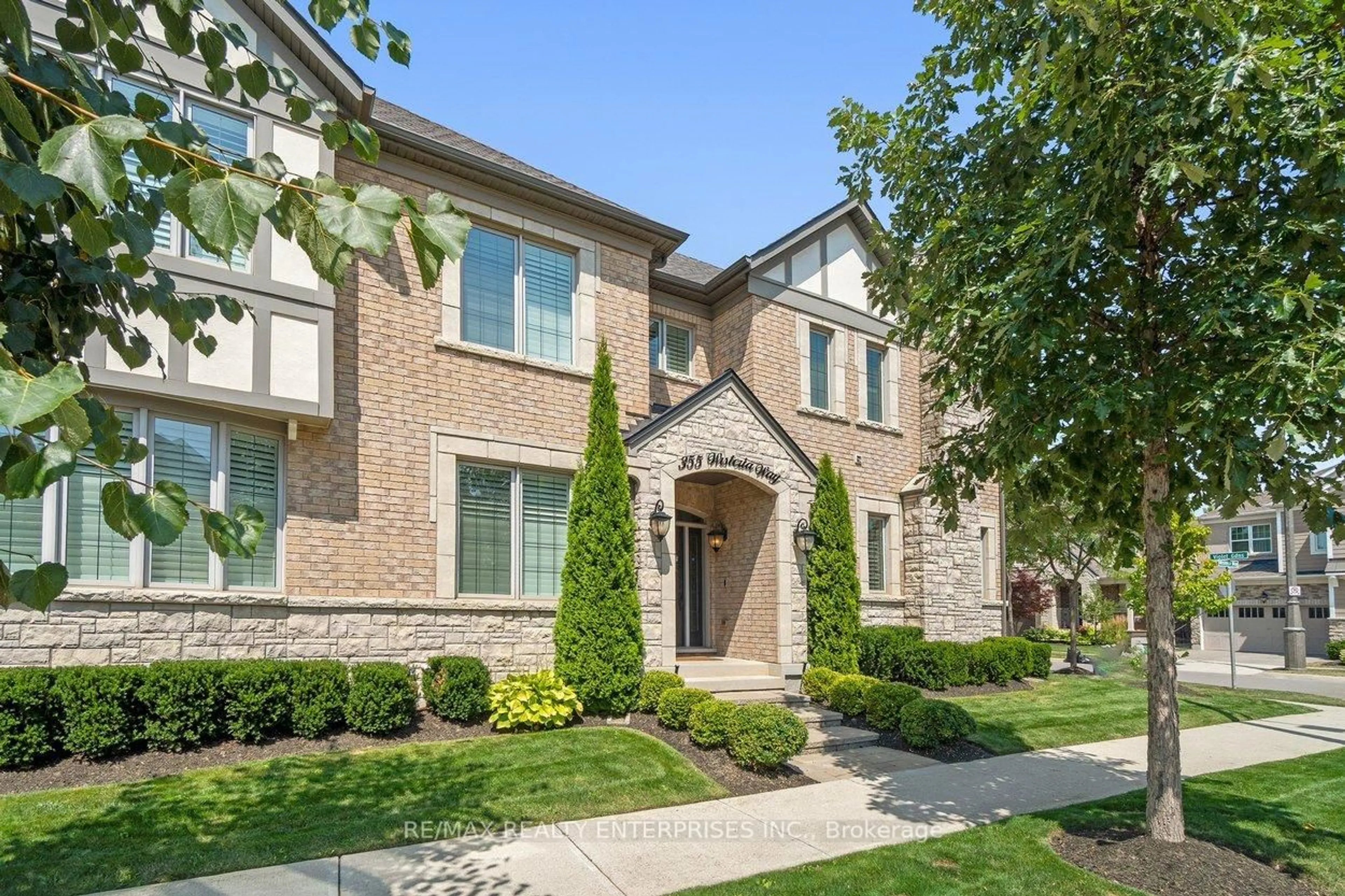 Home with brick exterior material, street for 355 Wisteria Way, Oakville Ontario L6M 1L6