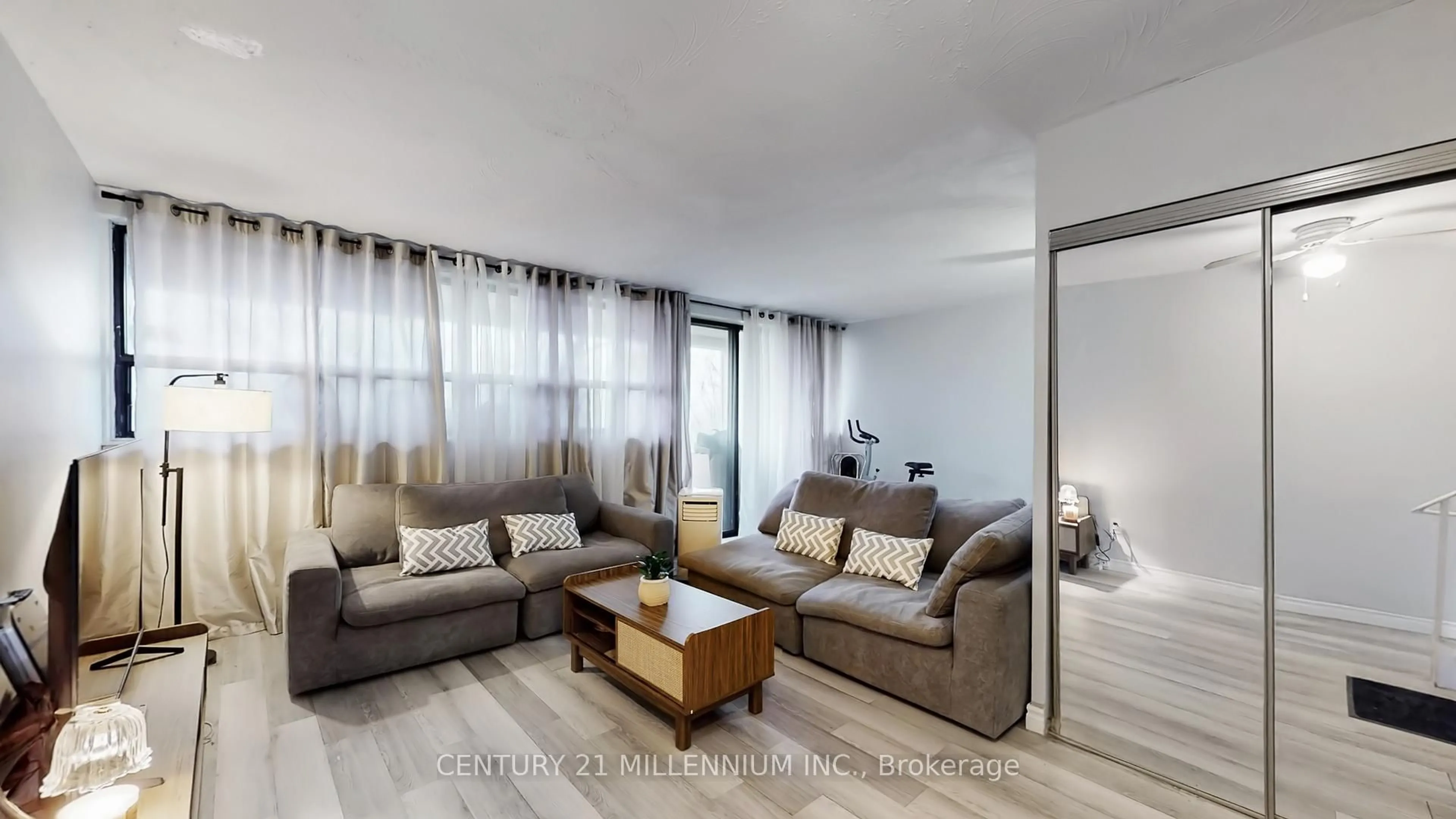 Living room with furniture, wood/laminate floor for 188 Mill St #204, Brampton Ontario L6Y 1T8