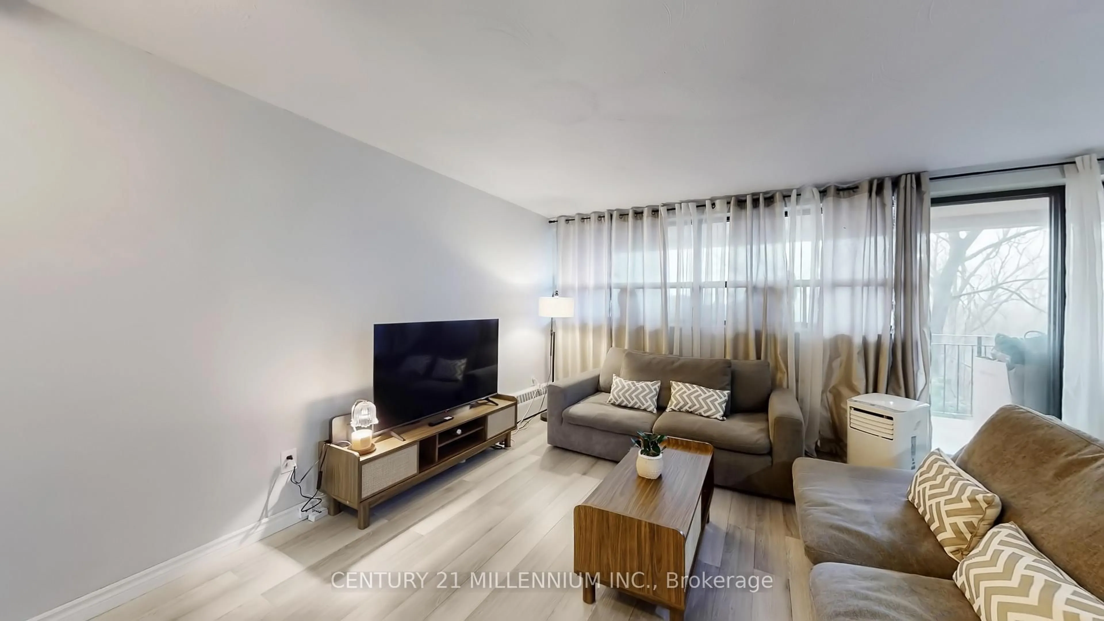 Living room with furniture, wood/laminate floor for 188 Mill St #204, Brampton Ontario L6Y 1T8