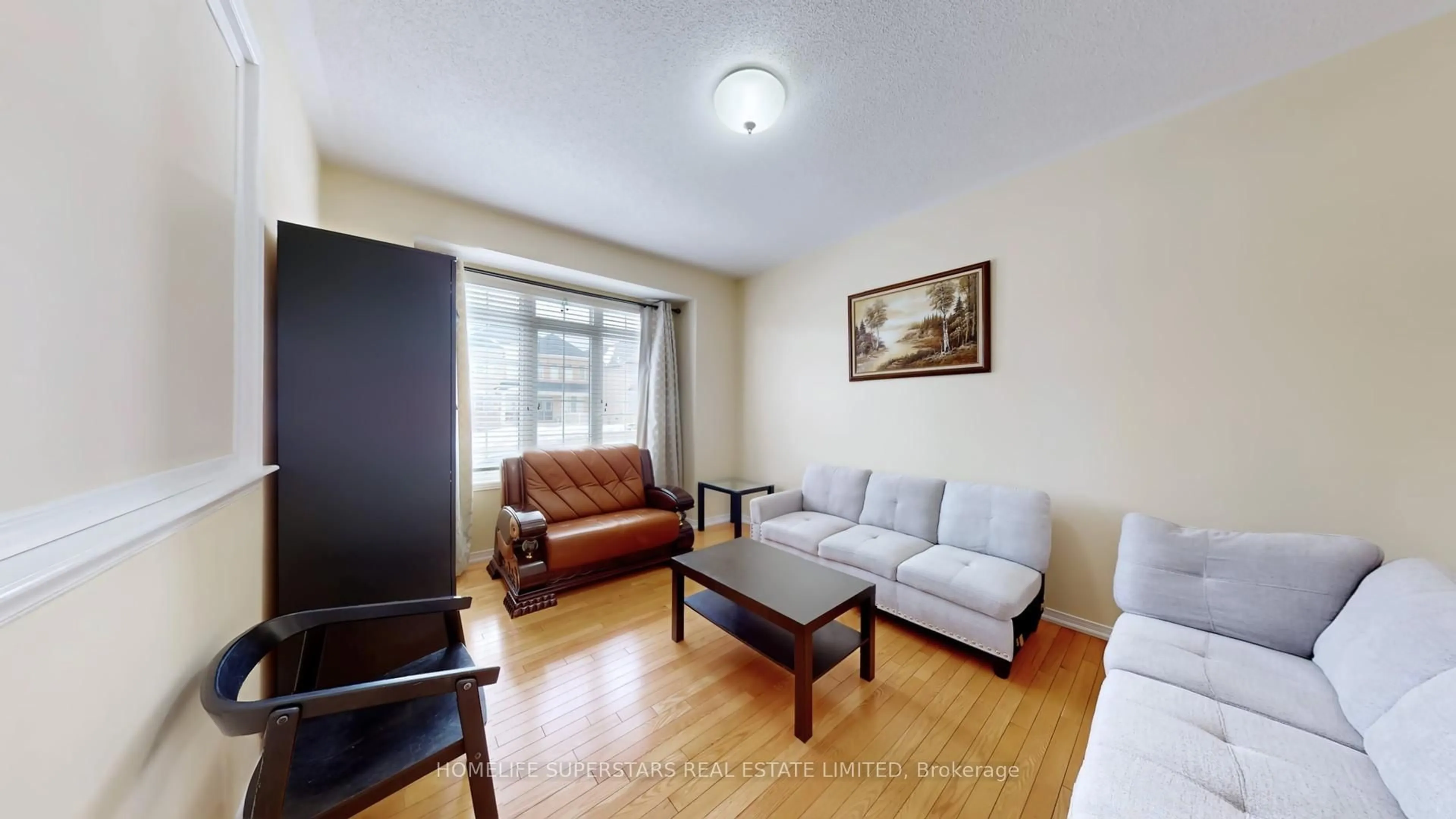 Living room with furniture, wood/laminate floor for 67 Bonnie Braes Dr, Brampton Ontario L6Y 0Y6