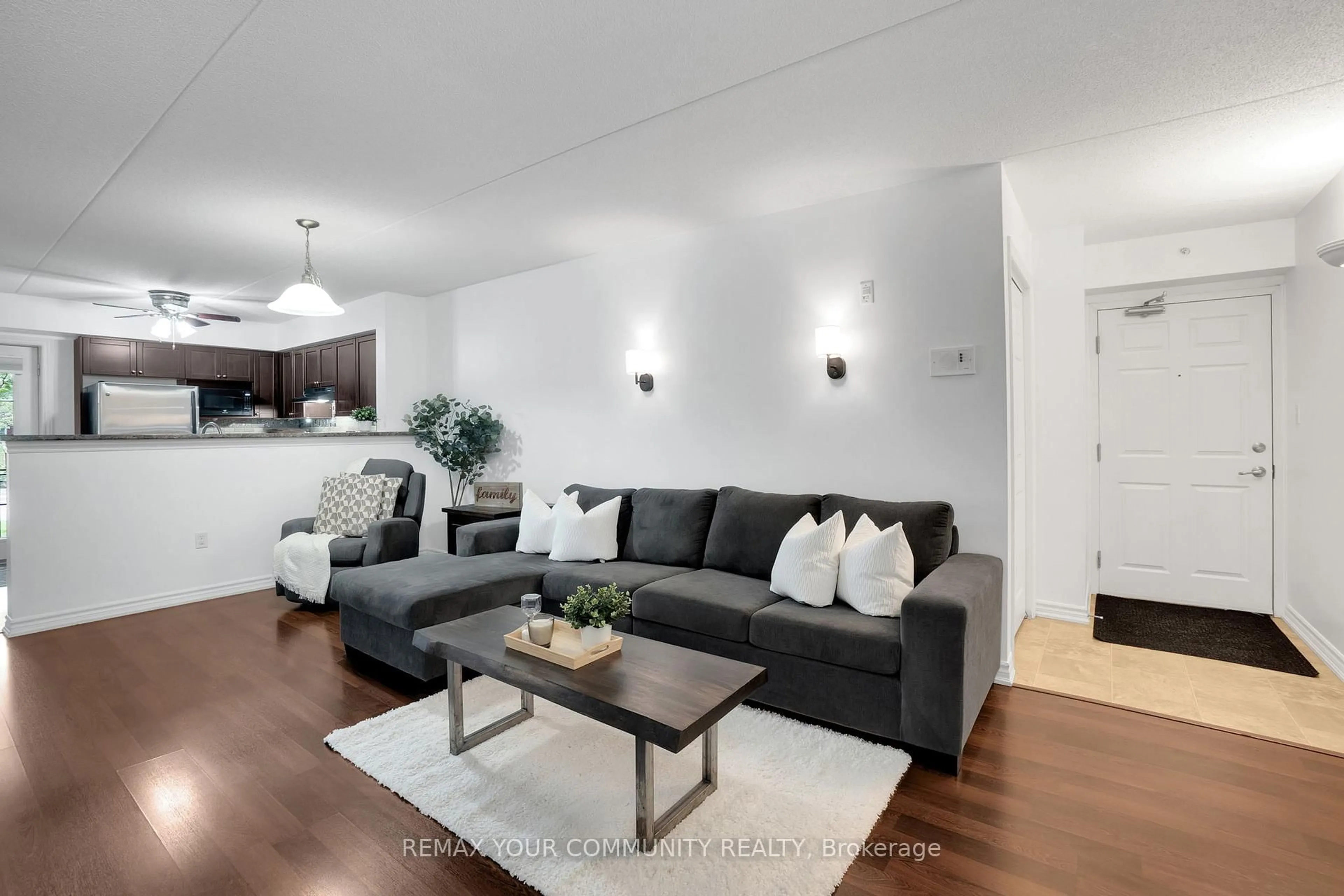 Living room with furniture, wood/laminate floor for 1360 Main St #101, Milton Ontario L9T 7S5