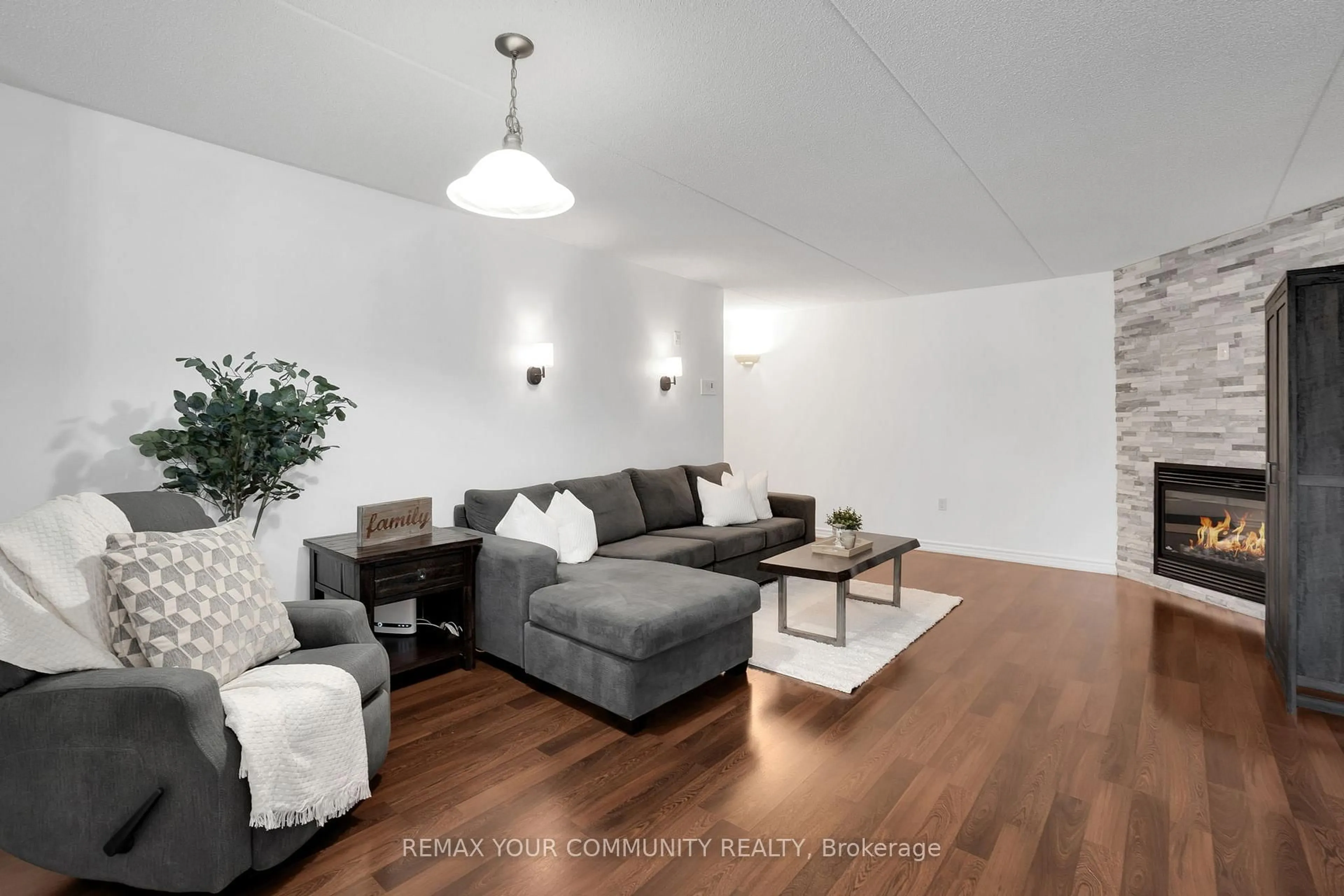 Living room with furniture, wood/laminate floor for 1360 Main St #101, Milton Ontario L9T 7S5