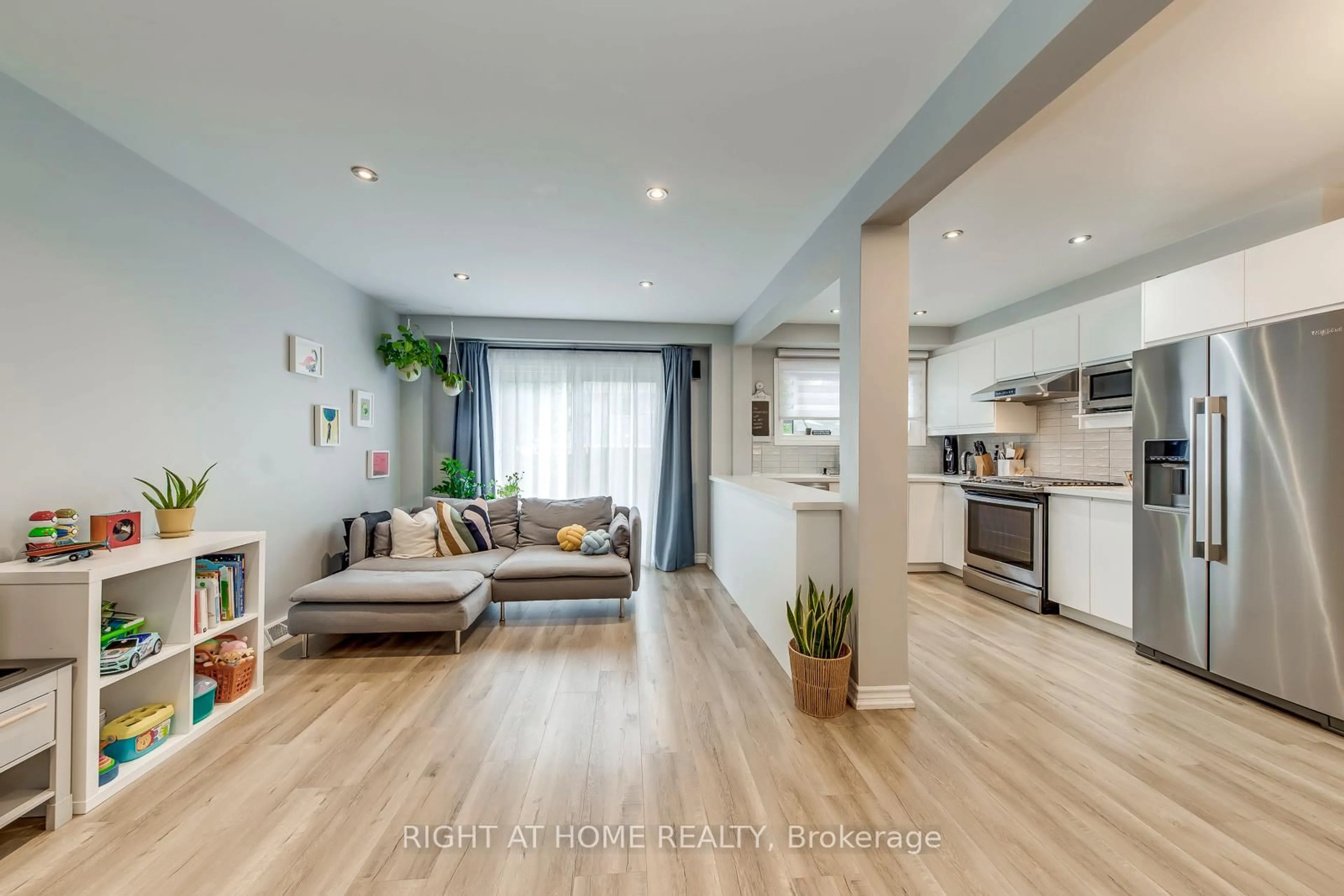 Living room with furniture, wood/laminate floor for 132 Ashton Cres, Brampton Ontario L6S 3J9