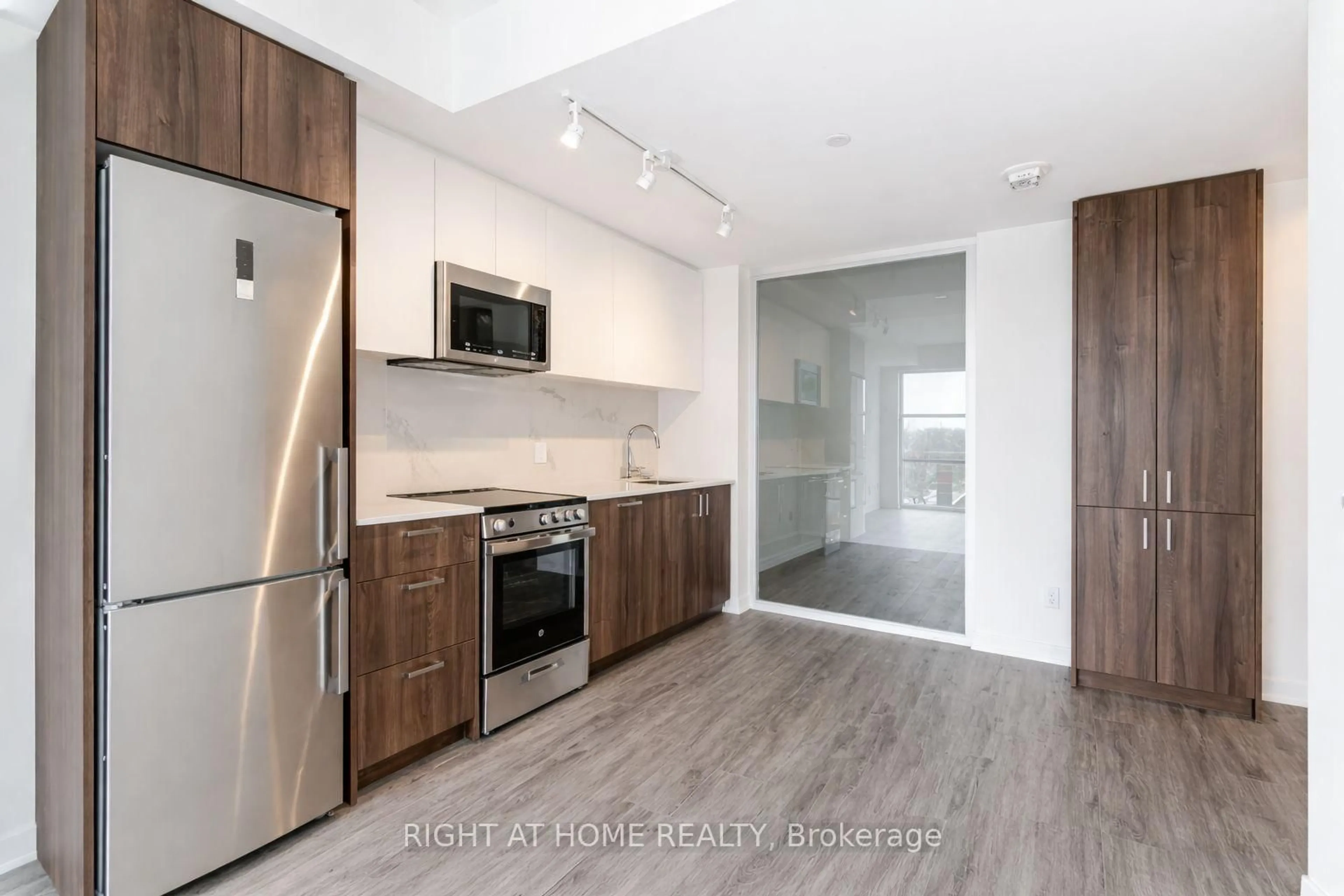 Open concept kitchen, wood/laminate floor for 1787 St Clair Ave #418, Toronto Ontario M6N 1J6