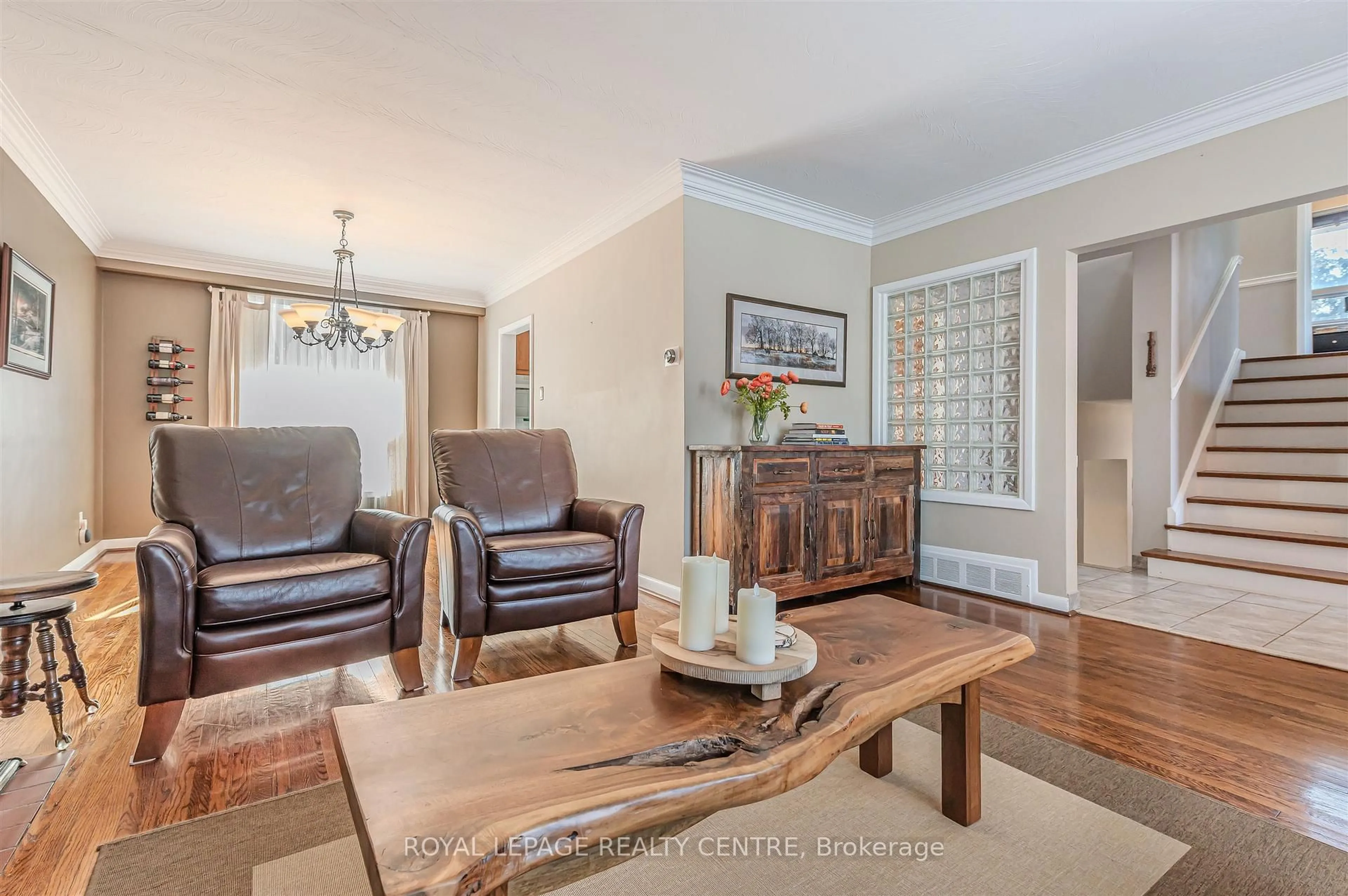 Living room with furniture, wood/laminate floor for 27 Hernshaw Cres, Toronto Ontario M9C 3M3