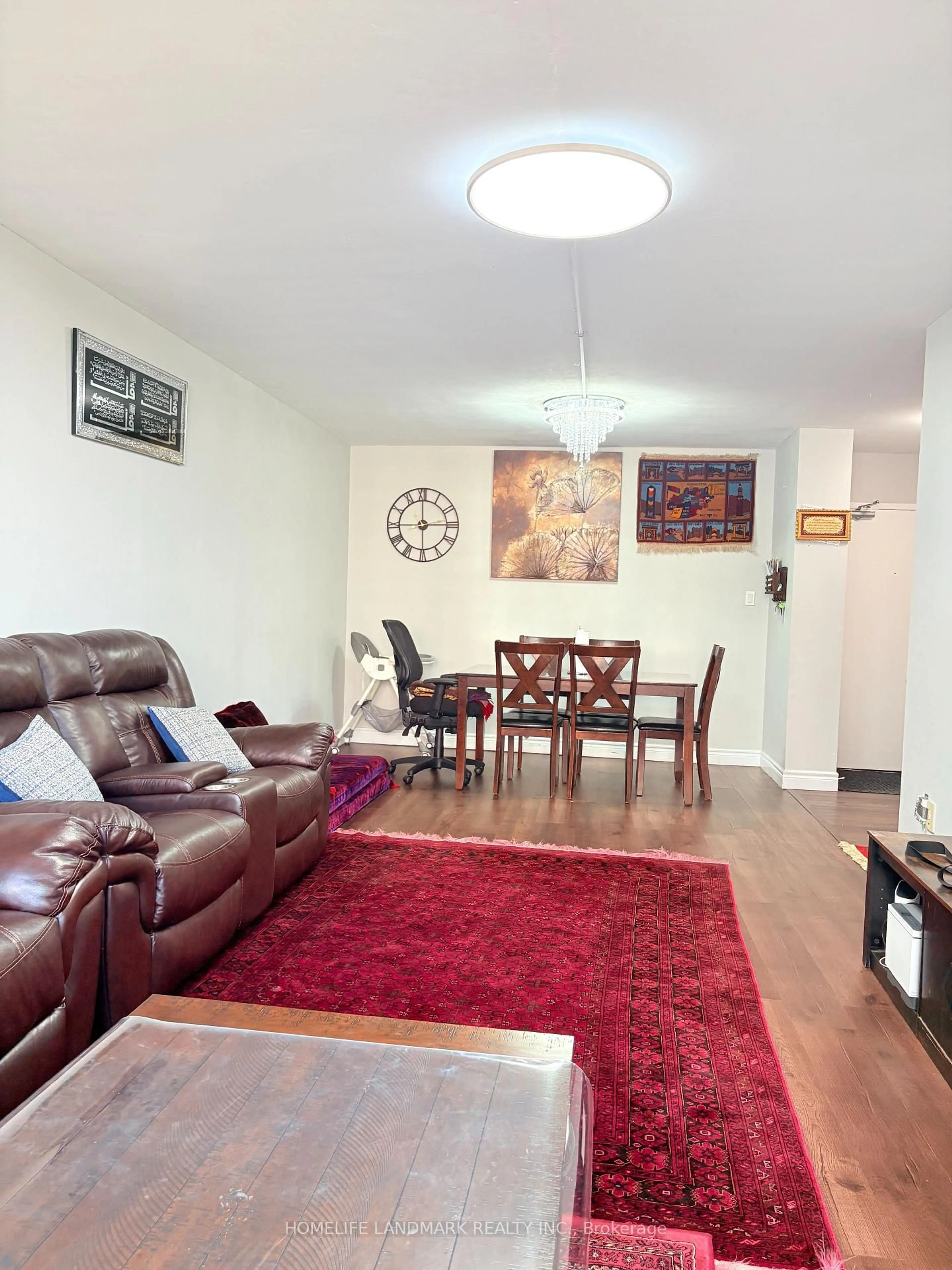 Living room with furniture, wood/laminate floor for 370 Dixon Rd #716, Toronto Ontario M9R 1T2