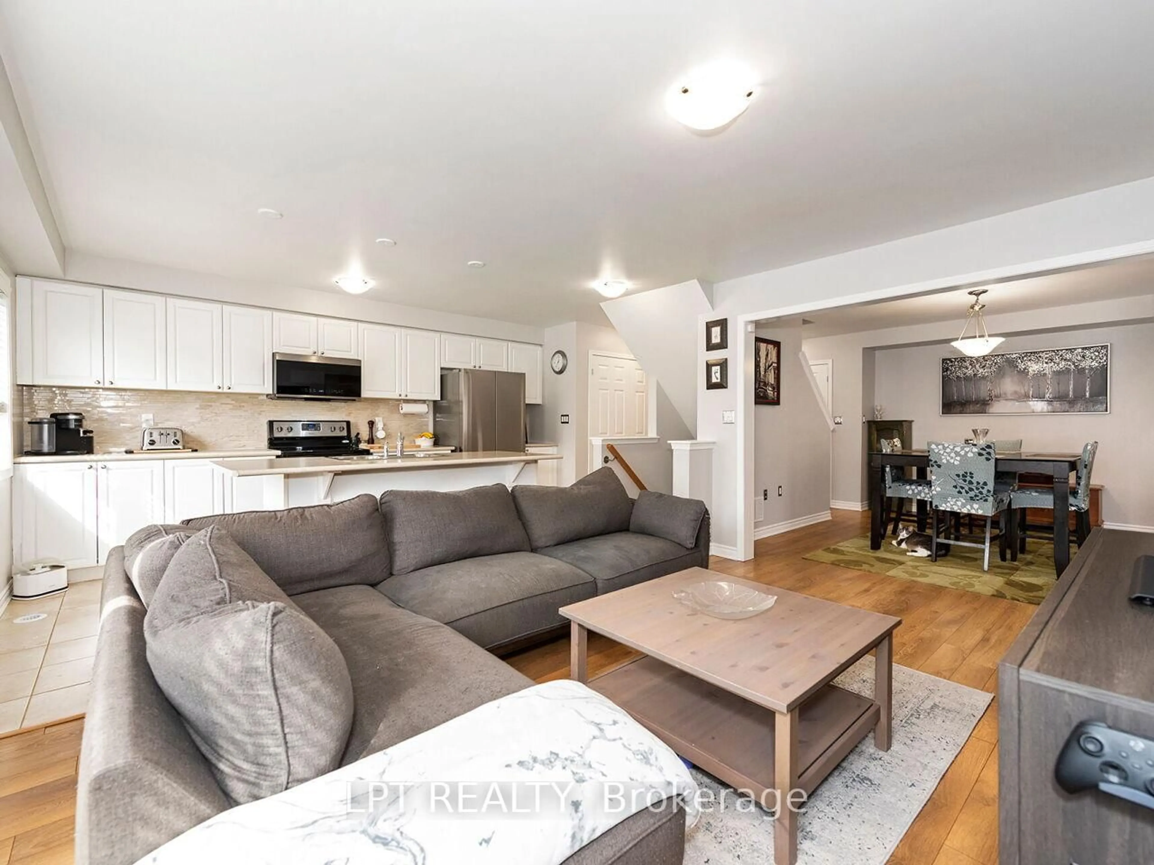 Living room with furniture, wood/laminate floor for 1585 Leblanc Crt, Milton Ontario L9E 0A4