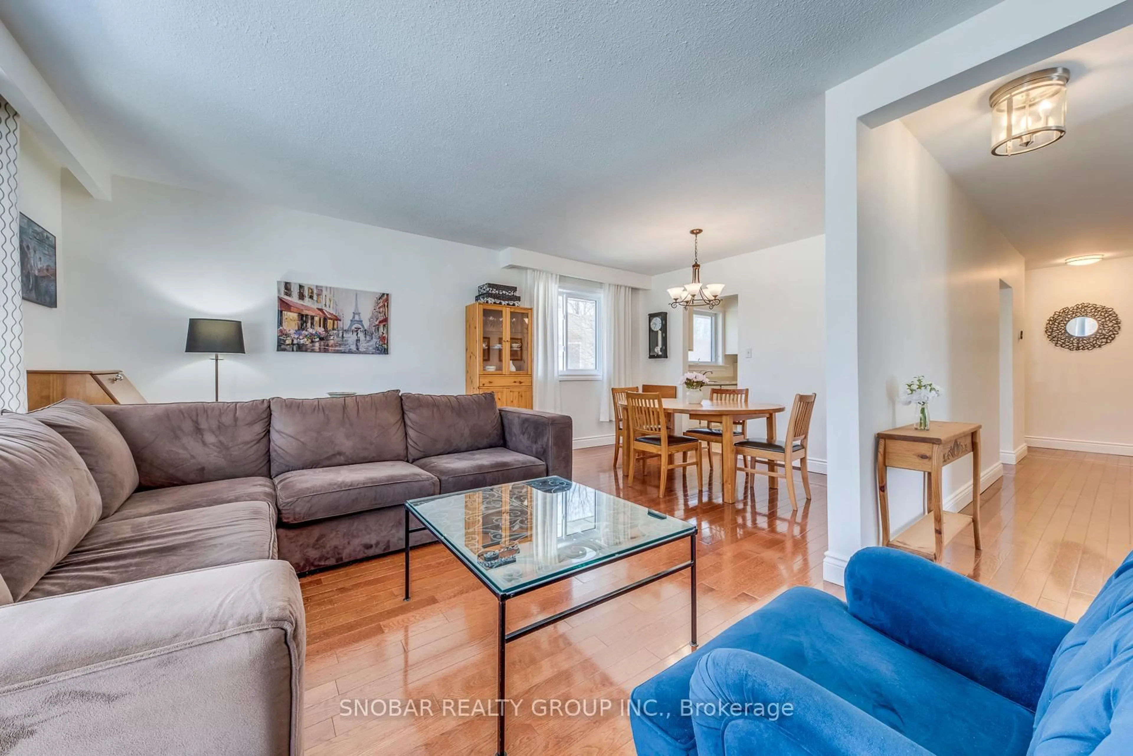 Living room with furniture, wood/laminate floor for 19 Powburn Pl, Toronto Ontario M9R 2C5