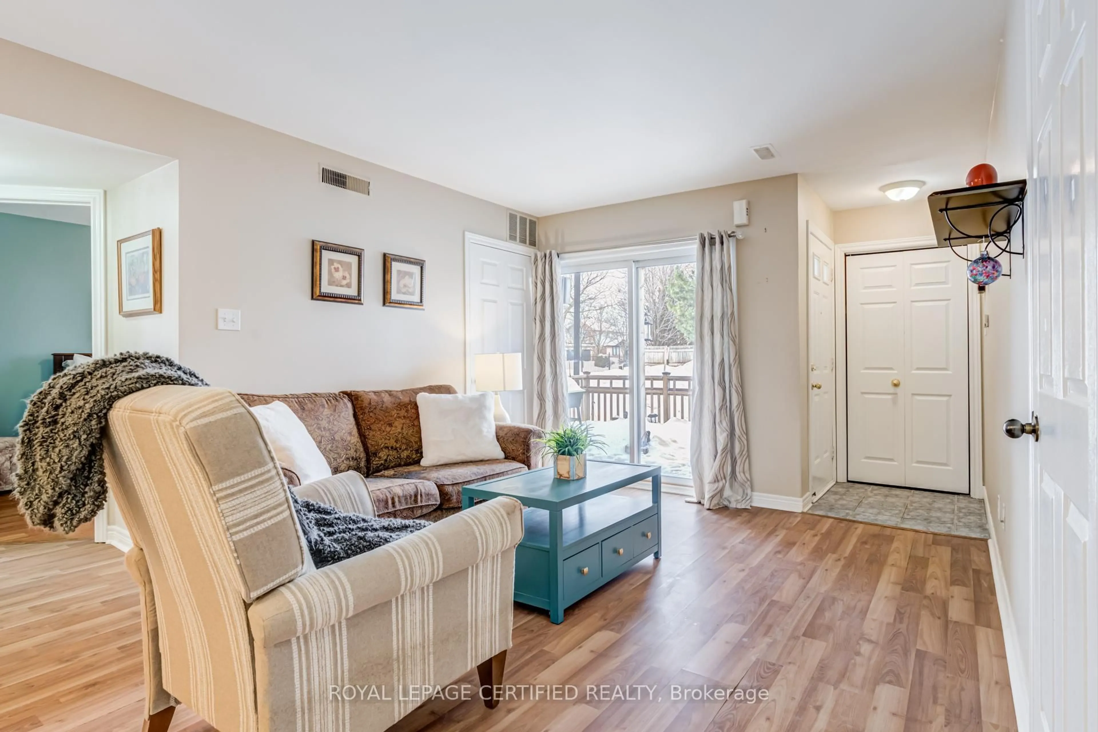 Living room with furniture, wood/laminate floor for 4140 Foxwood Dr #801, Burlington Ontario L7M 4R4