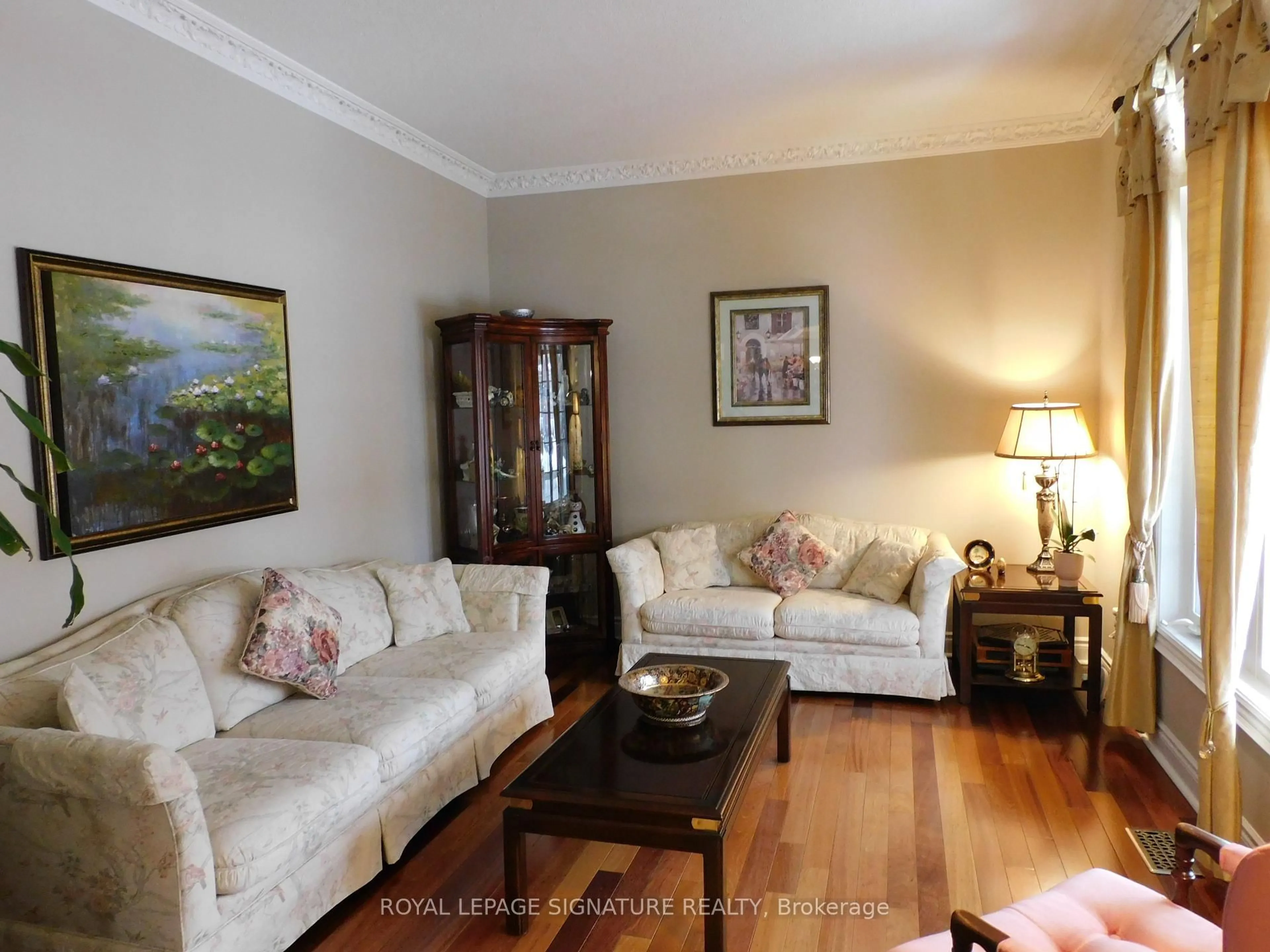 Living room with furniture, wood/laminate floor for 1590 Hallstone Rd, Brampton Ontario L6Y 5K8