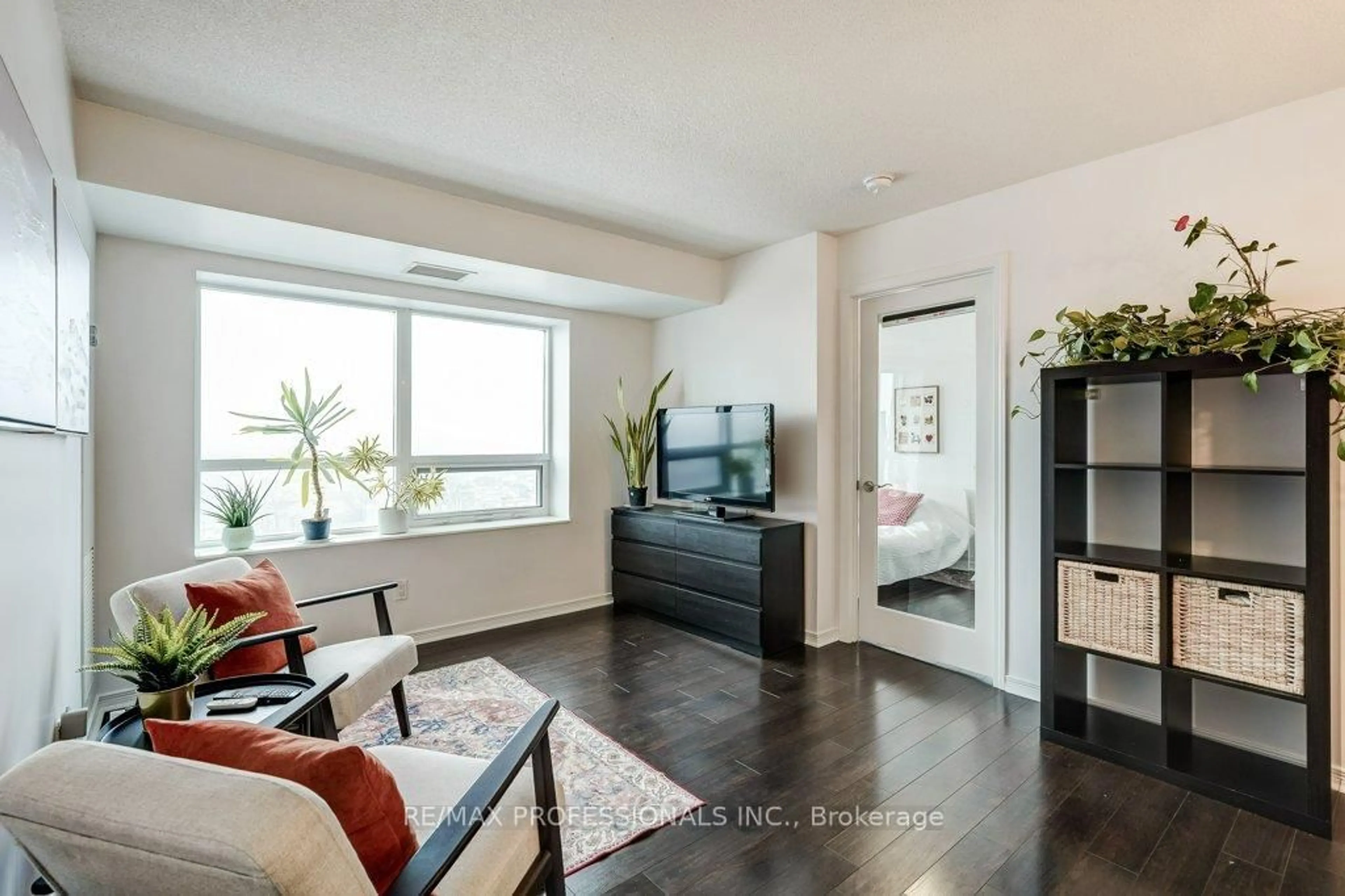 Living room with furniture, wood/laminate floor for 60 Heintzman St #930, Toronto Ontario M6P 5A1