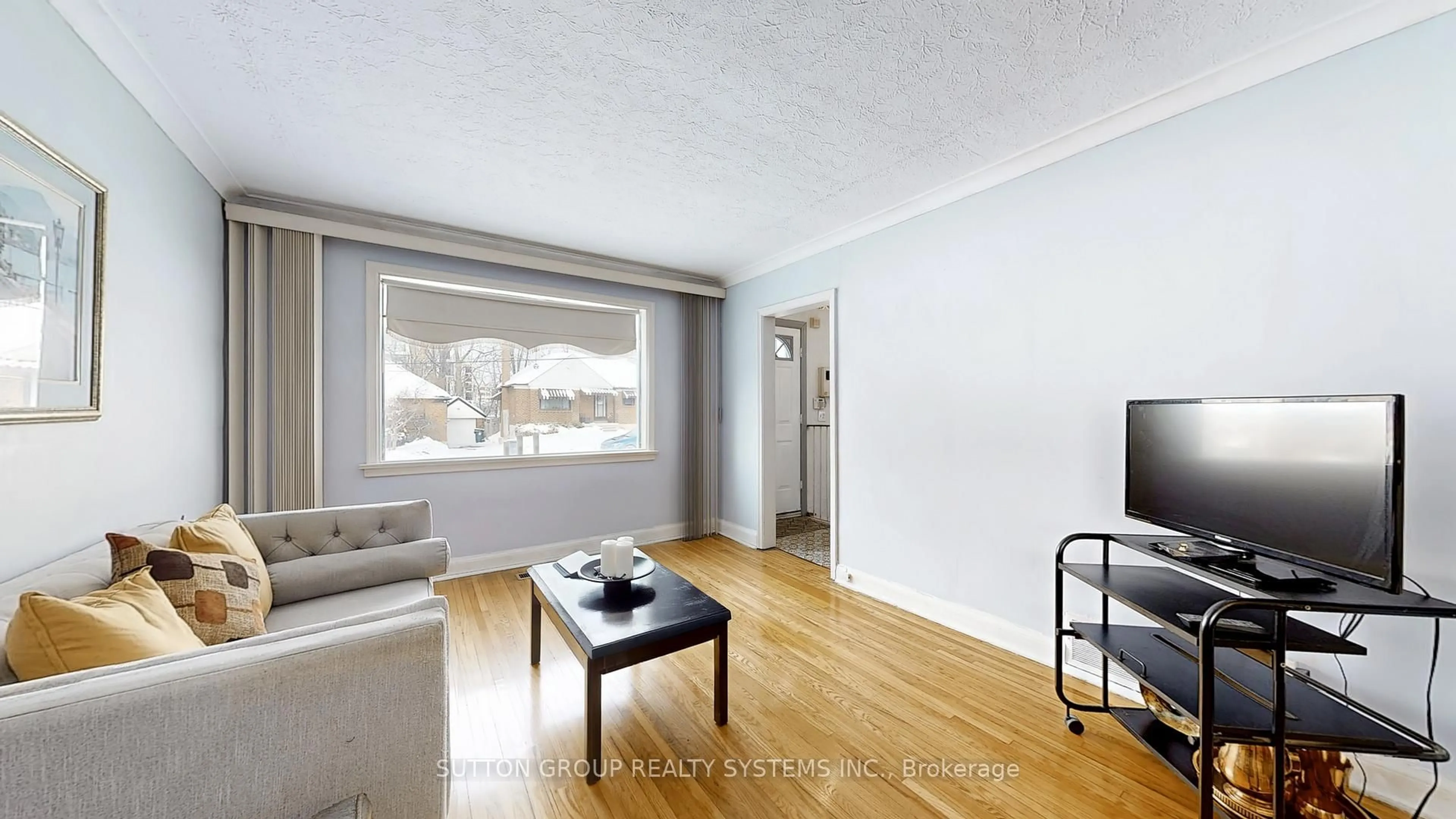 Living room with furniture, wood/laminate floor for 199 Strathnairn Ave, Toronto Ontario M6M 2G6