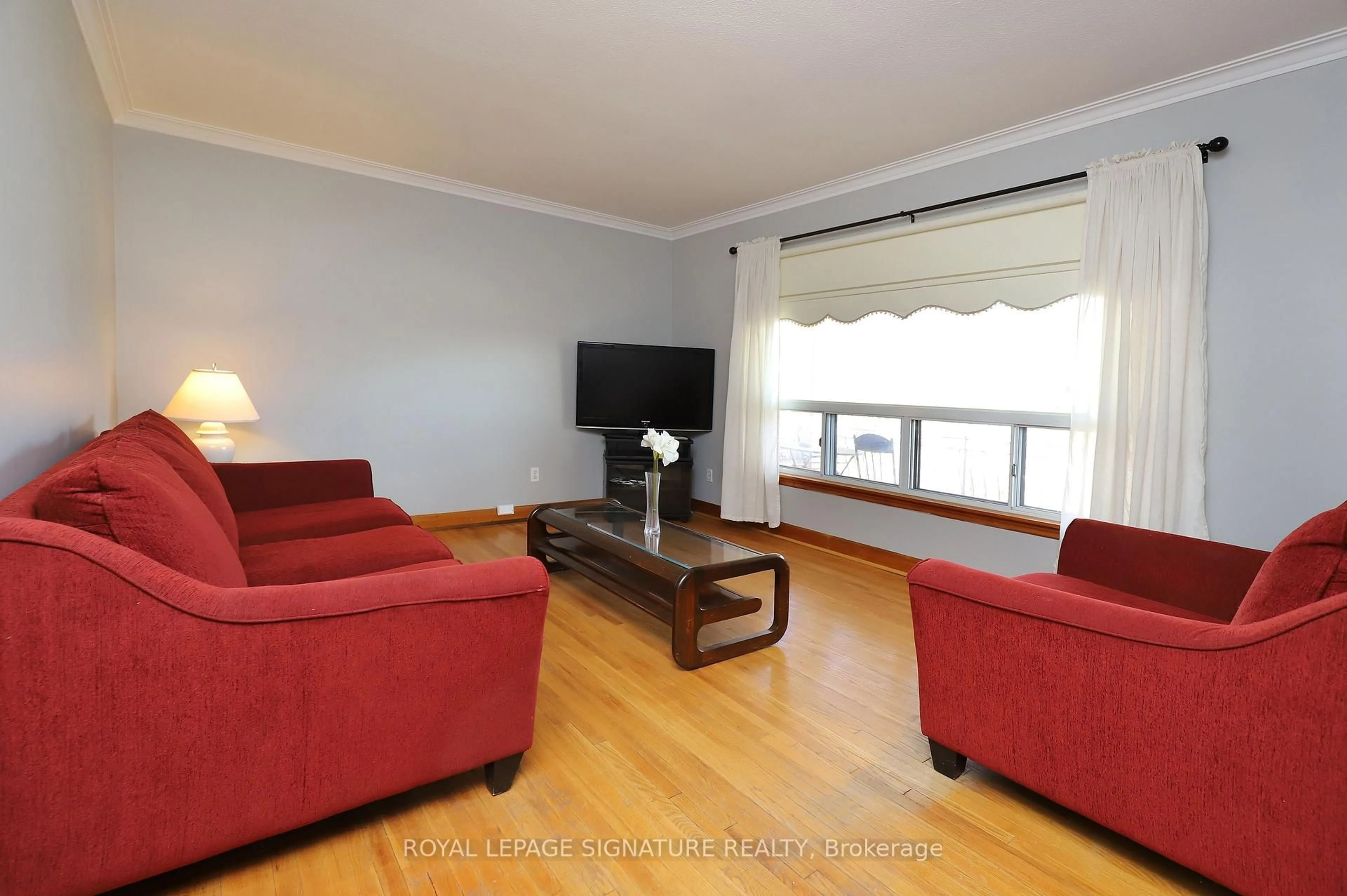 Living room with furniture, wood/laminate floor for 56 Wendell Ave, Toronto Ontario M9N 3K7