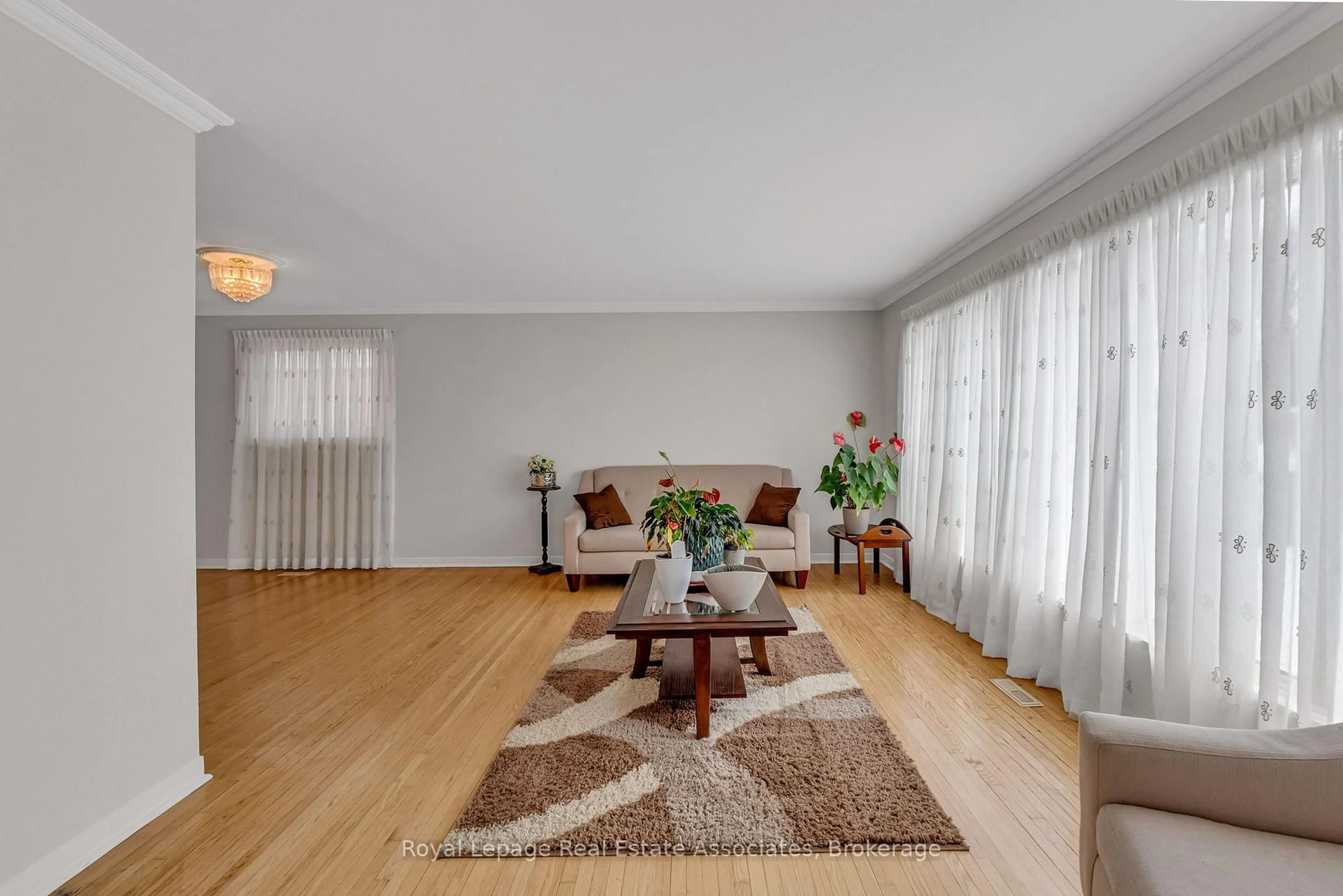 Living room with furniture, wood/laminate floor for 56 Brookland Dr, Brampton Ontario L6T 2M5