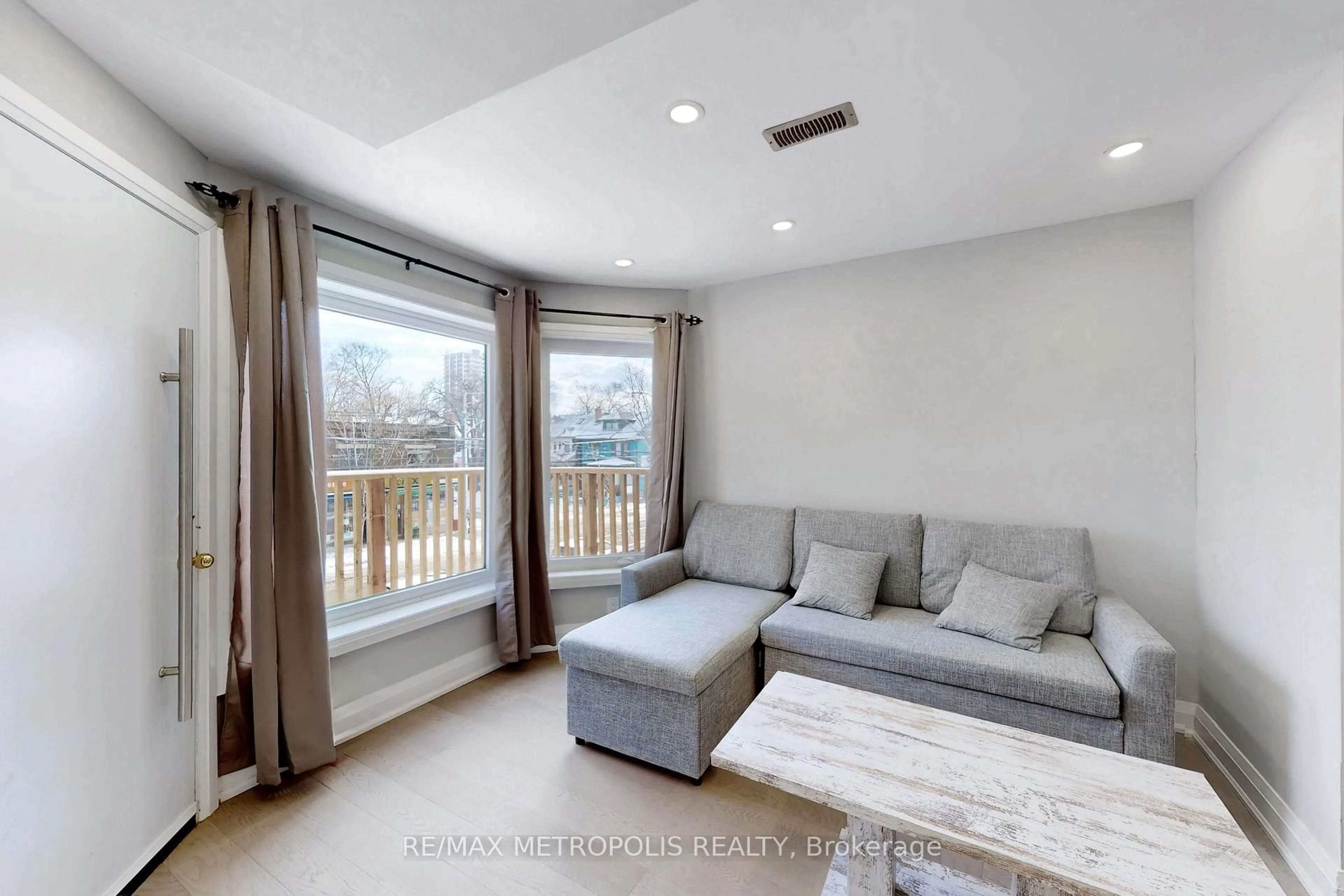 Living room with furniture, wood/laminate floor for 74 Roncesvalles Ave, Toronto Ontario M6R 2K7