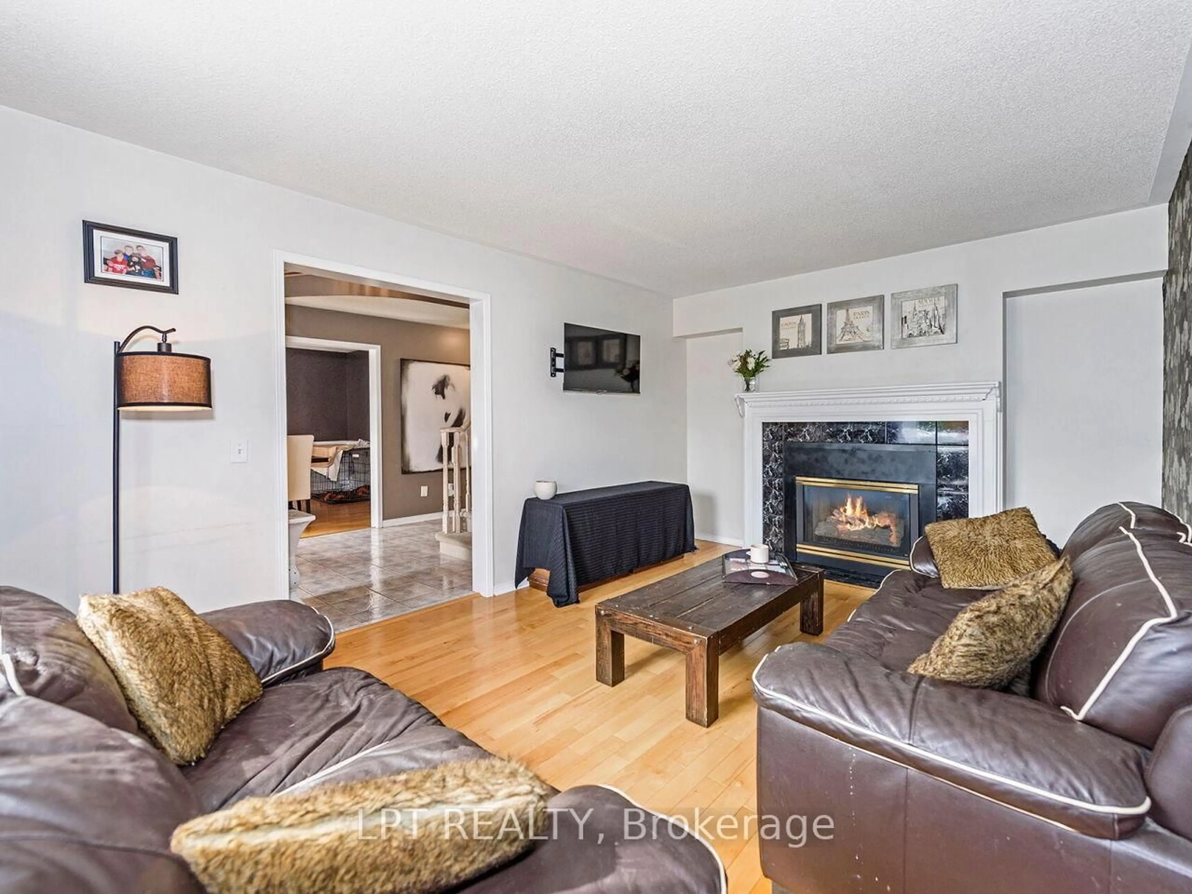 Living room with furniture, wood/laminate floor for 2460 Sixth Line, Oakville Ontario L6H 5Z8
