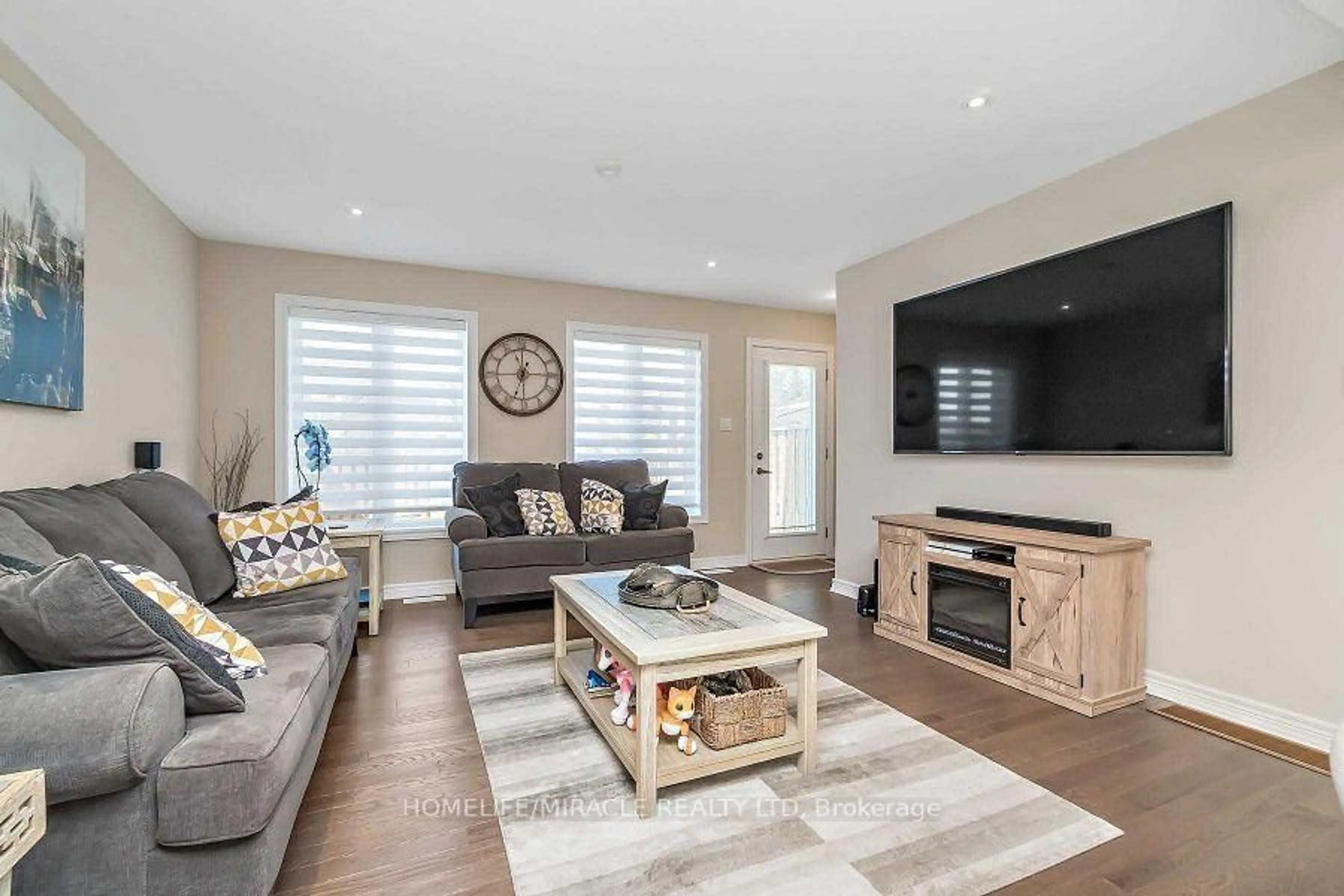 Living room with furniture, wood/laminate floor for 26 Winterton Crt, Orangeville Ontario L9W 7N5