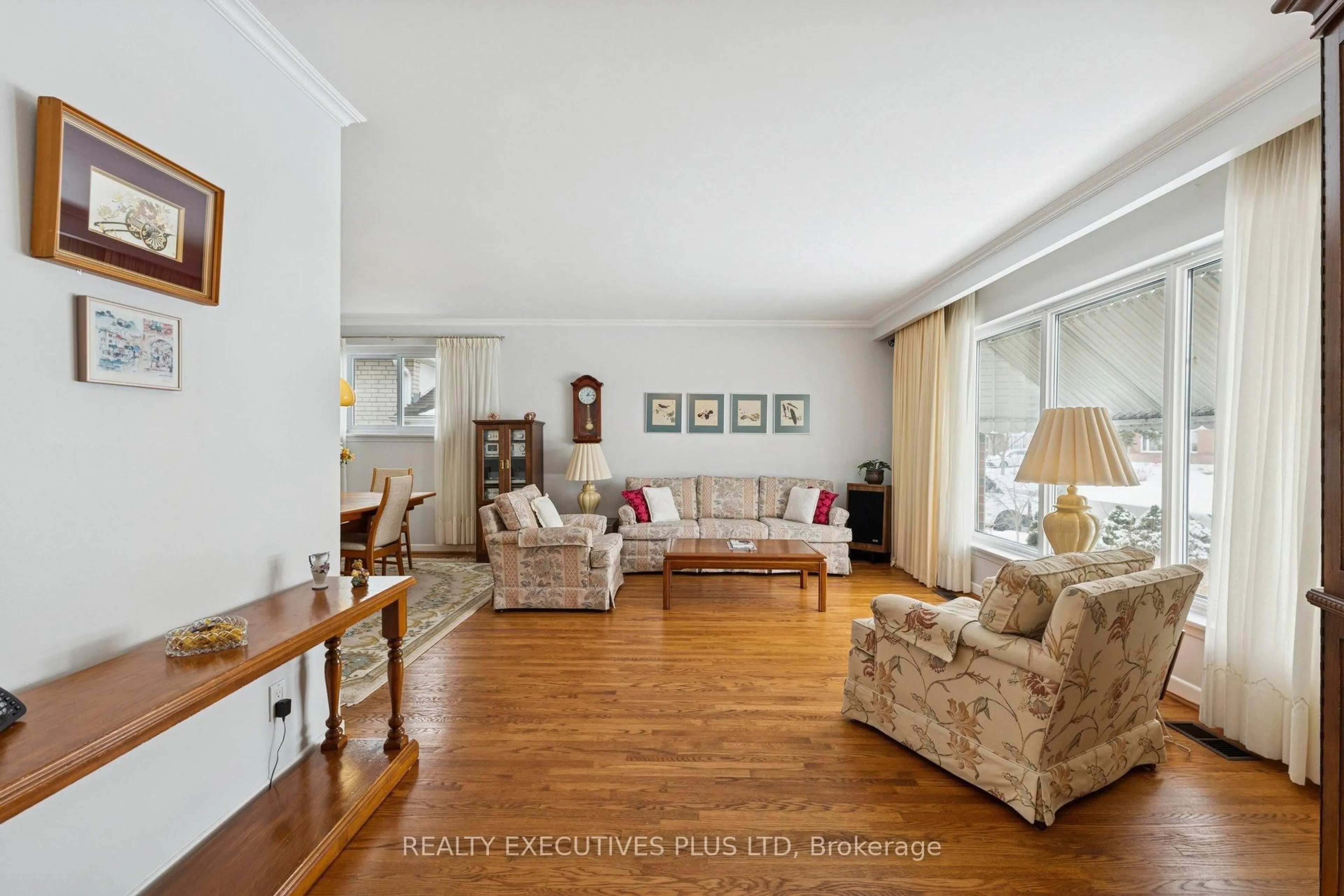 Living room with furniture, wood/laminate floor for 23 Helmsdale Cres, Toronto Ontario M9V 3X8