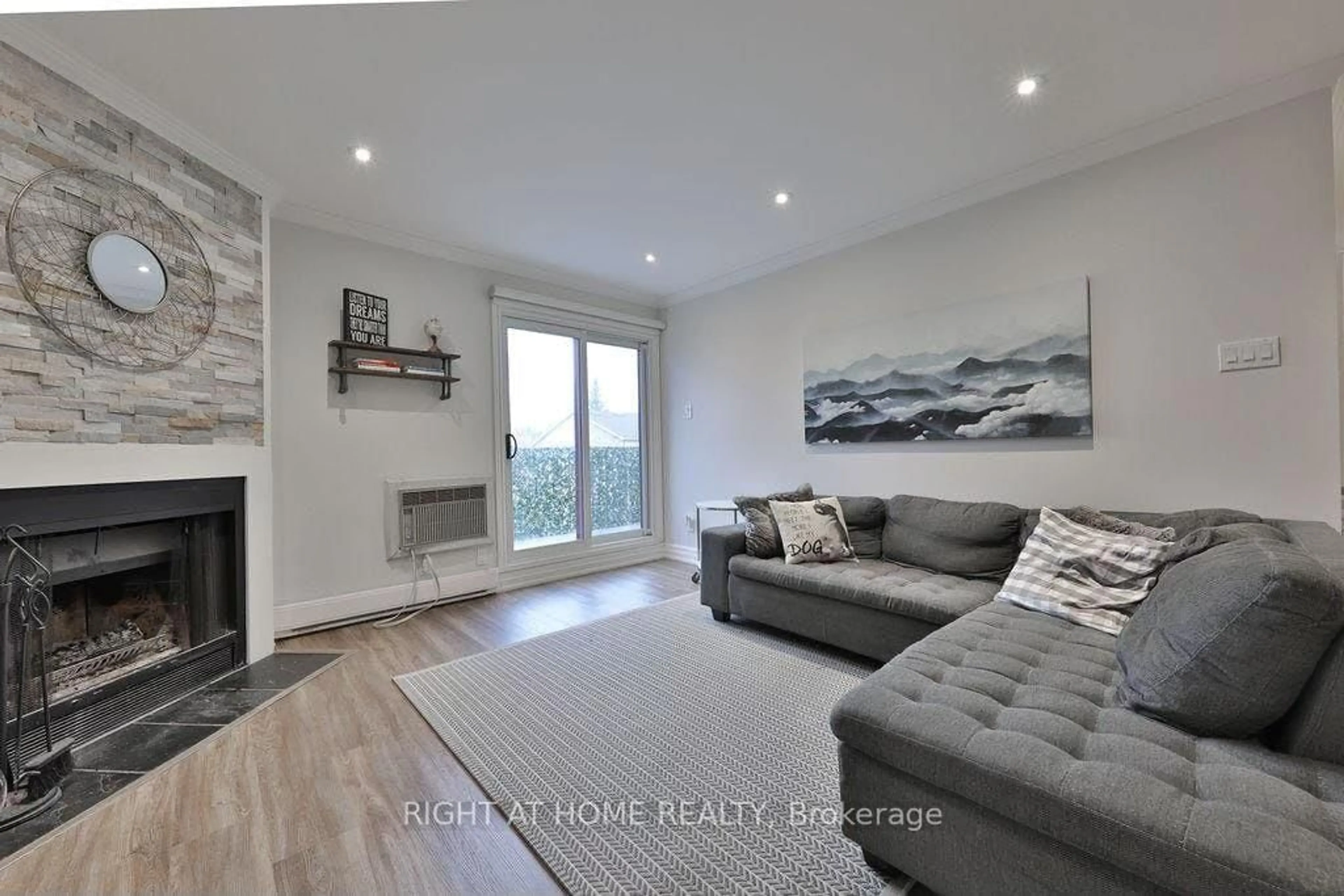 Living room with furniture, wood/laminate floor for 1498 Pilgrims Way #234, Oakville Ontario L6M 3G9