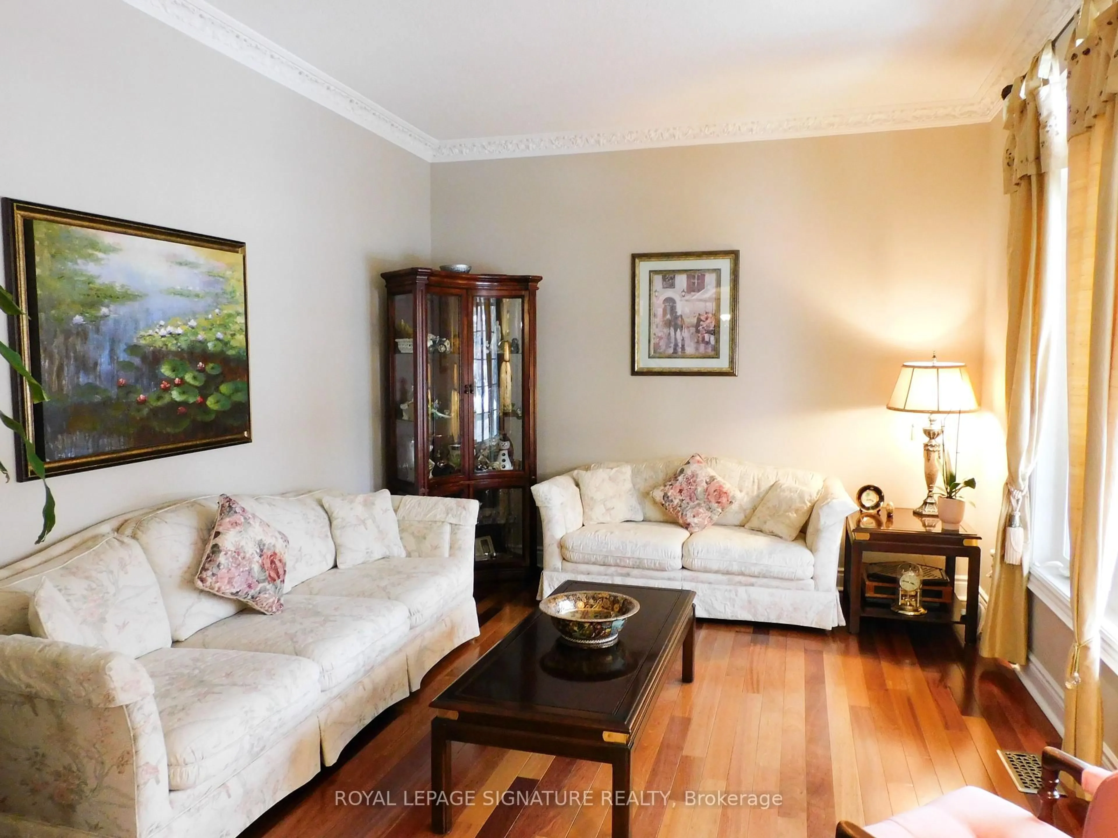 Living room with furniture, wood/laminate floor for 1590 Hallstone Rd, Brampton Ontario L6Y 5K8