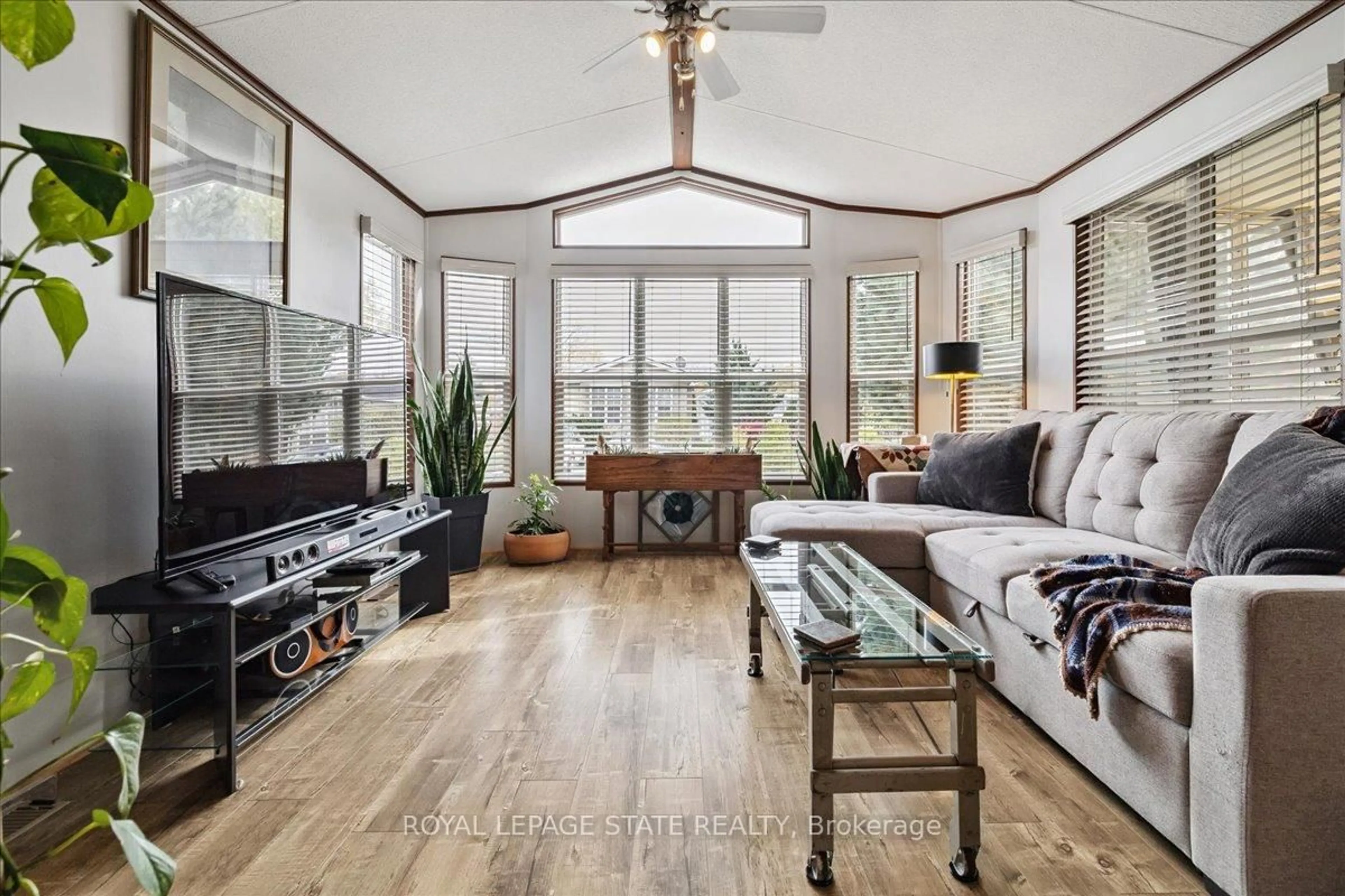 Living room with furniture, wood/laminate floor for 4449 Milburough Line #13 Spruce, Burlington Ontario L7P 0C5