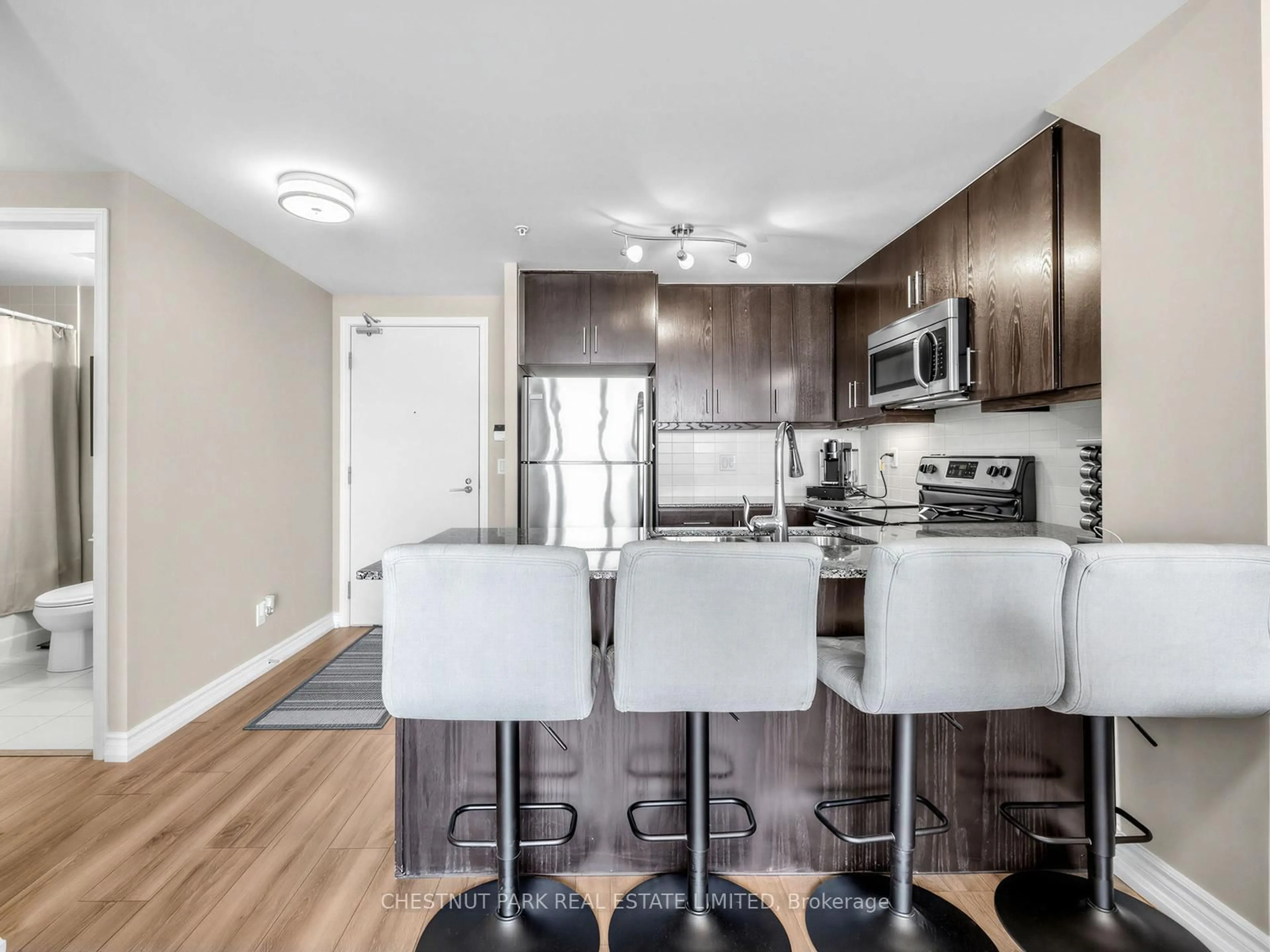 Open concept kitchen, wood/laminate floor for 15 James Finlay Way #613, Toronto Ontario M3M 0B3