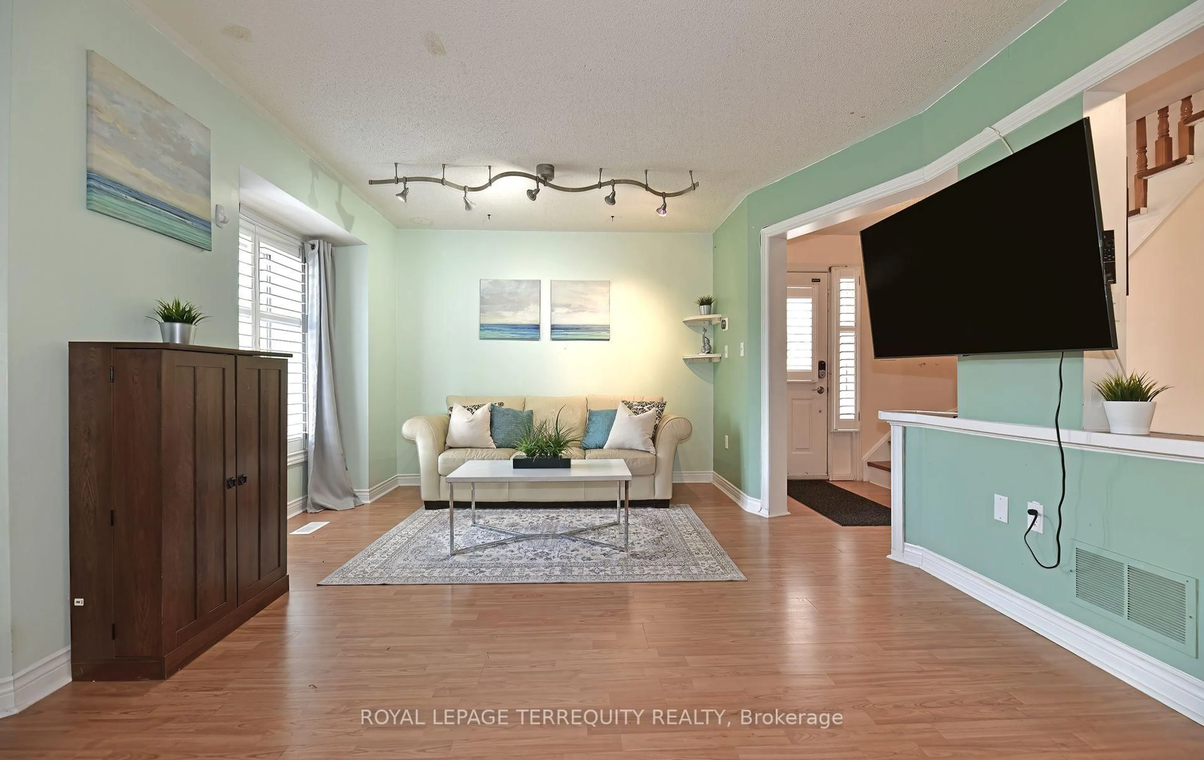 Living room with furniture, wood/laminate floor for 154 Pressed Brick Dr, Brampton Ontario L6V 4K6