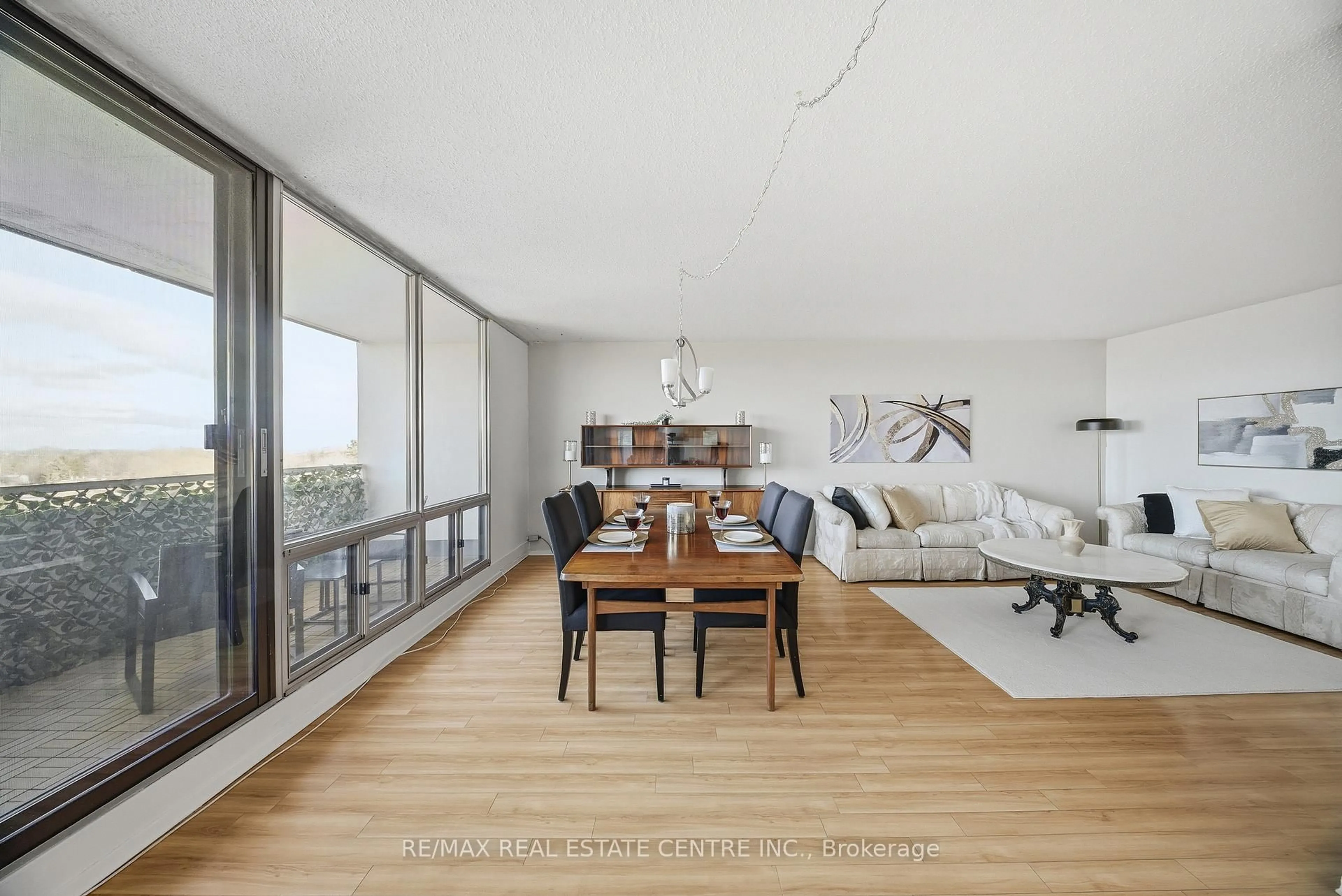 Living room with furniture, wood/laminate floor for 2055 Upper Middle Rd #602, Burlington Ontario L7P 3P4