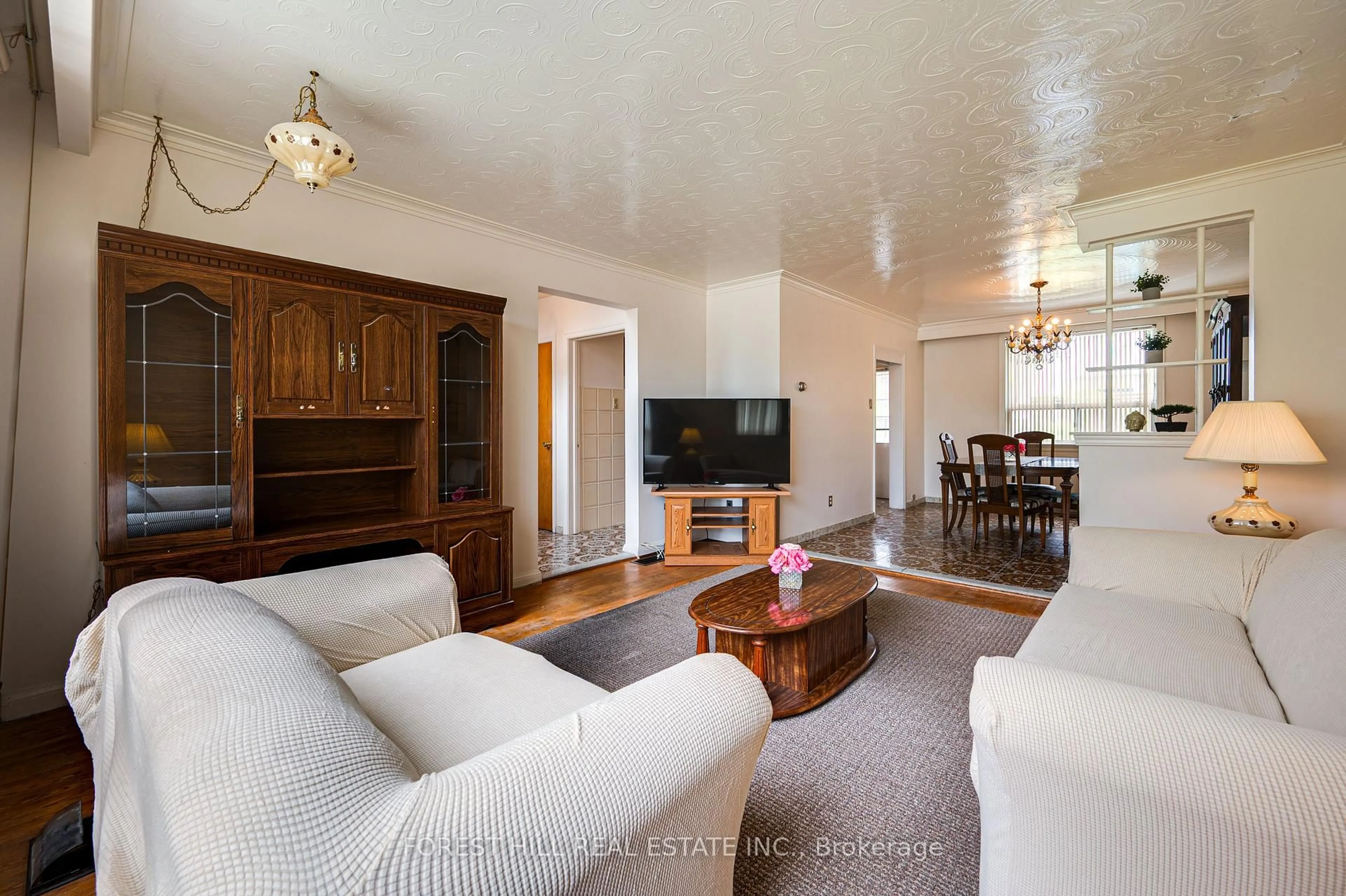 Living room with furniture, wood/laminate floor for 73 Talent Cres, Toronto Ontario M9M 2N5