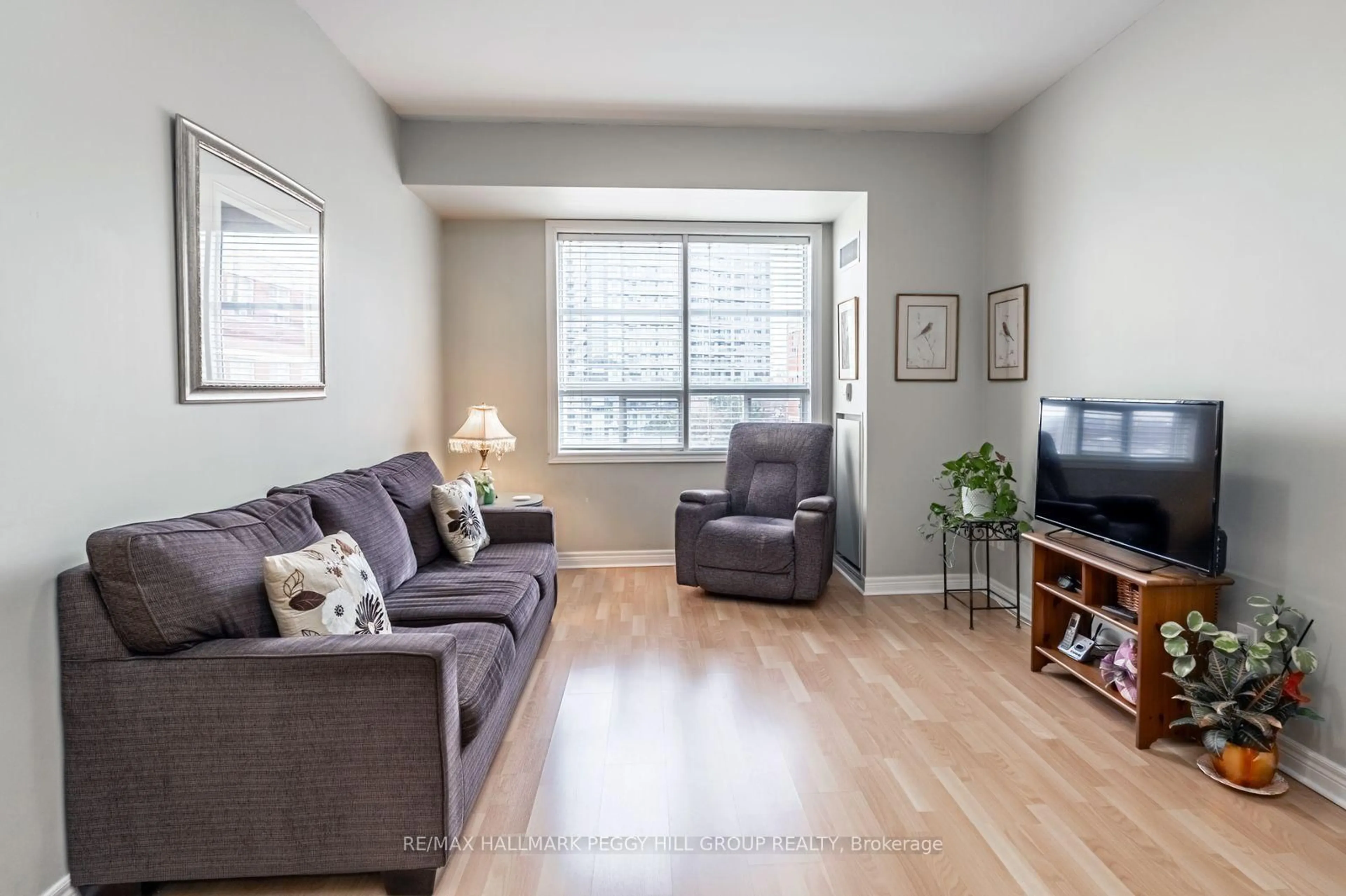 Living room with furniture, wood/laminate floor for 1415 Lawrence Ave #319, Toronto Ontario M6L 1A9