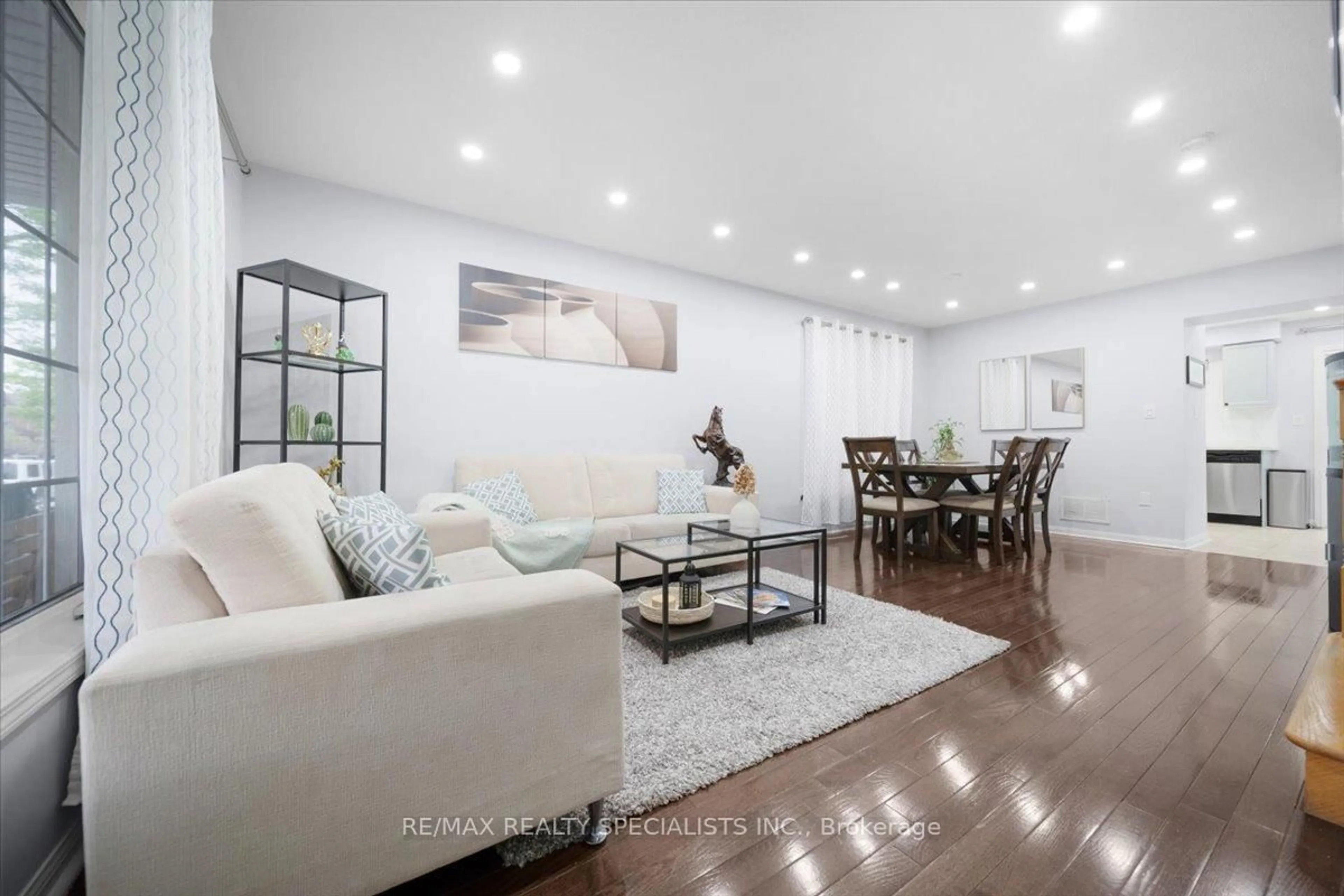 Living room with furniture, wood/laminate floor for 28 Redcastle St, Brampton Ontario L7A 1Y5