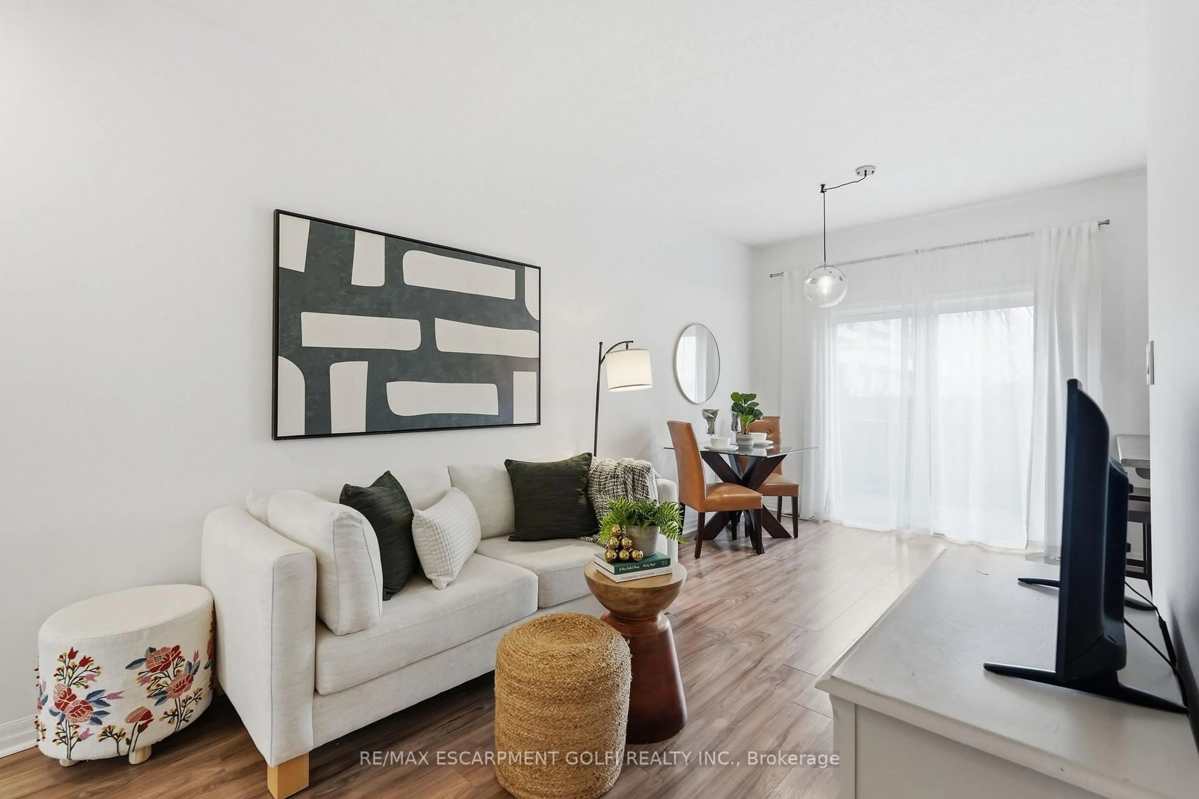 Living room with furniture, wood/laminate floor for 70 Plains Rd #12, Burlington Ontario L7T 0B6