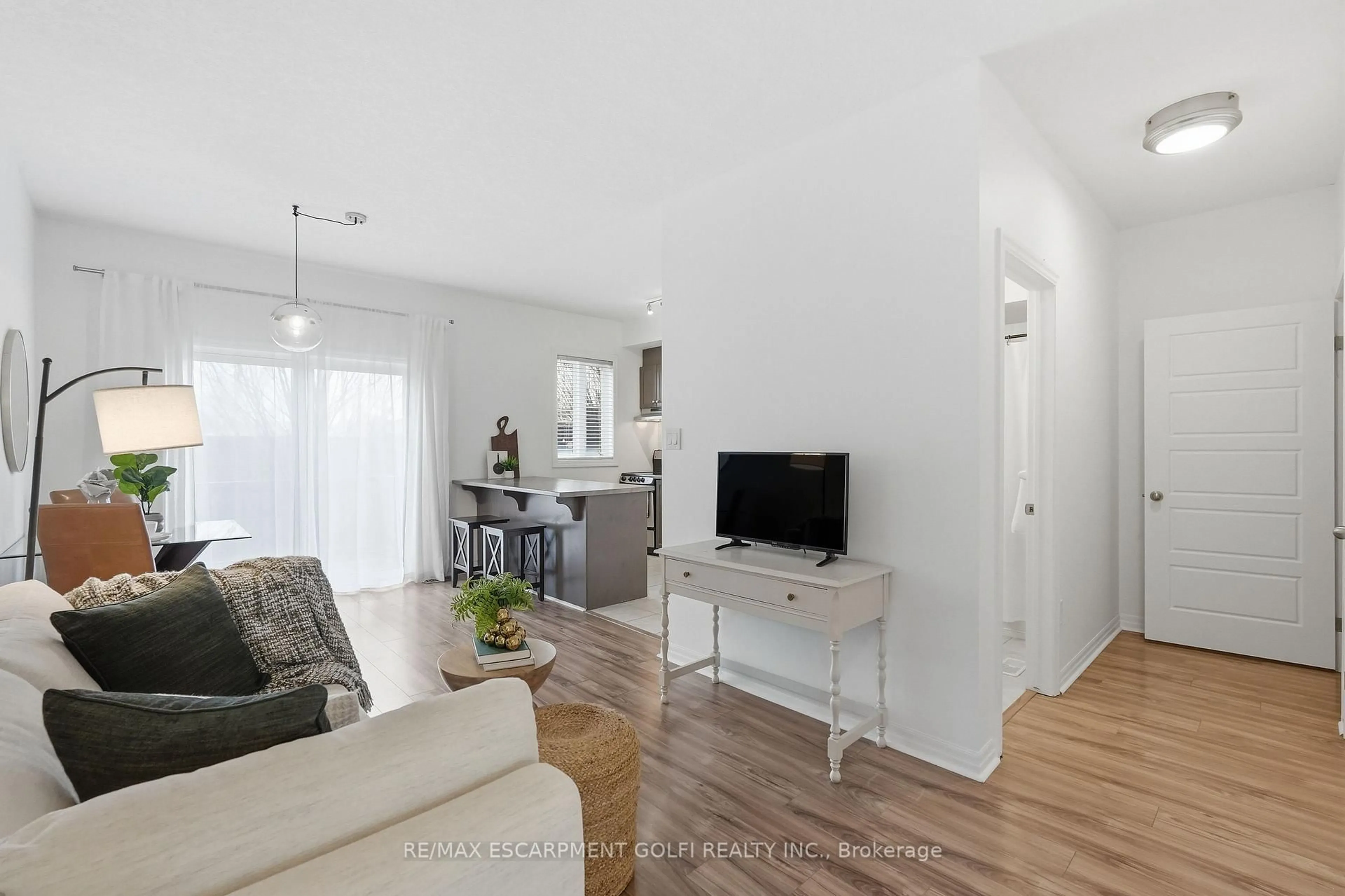 Living room with furniture, wood/laminate floor for 70 Plains Rd #12, Burlington Ontario L7T 0B6