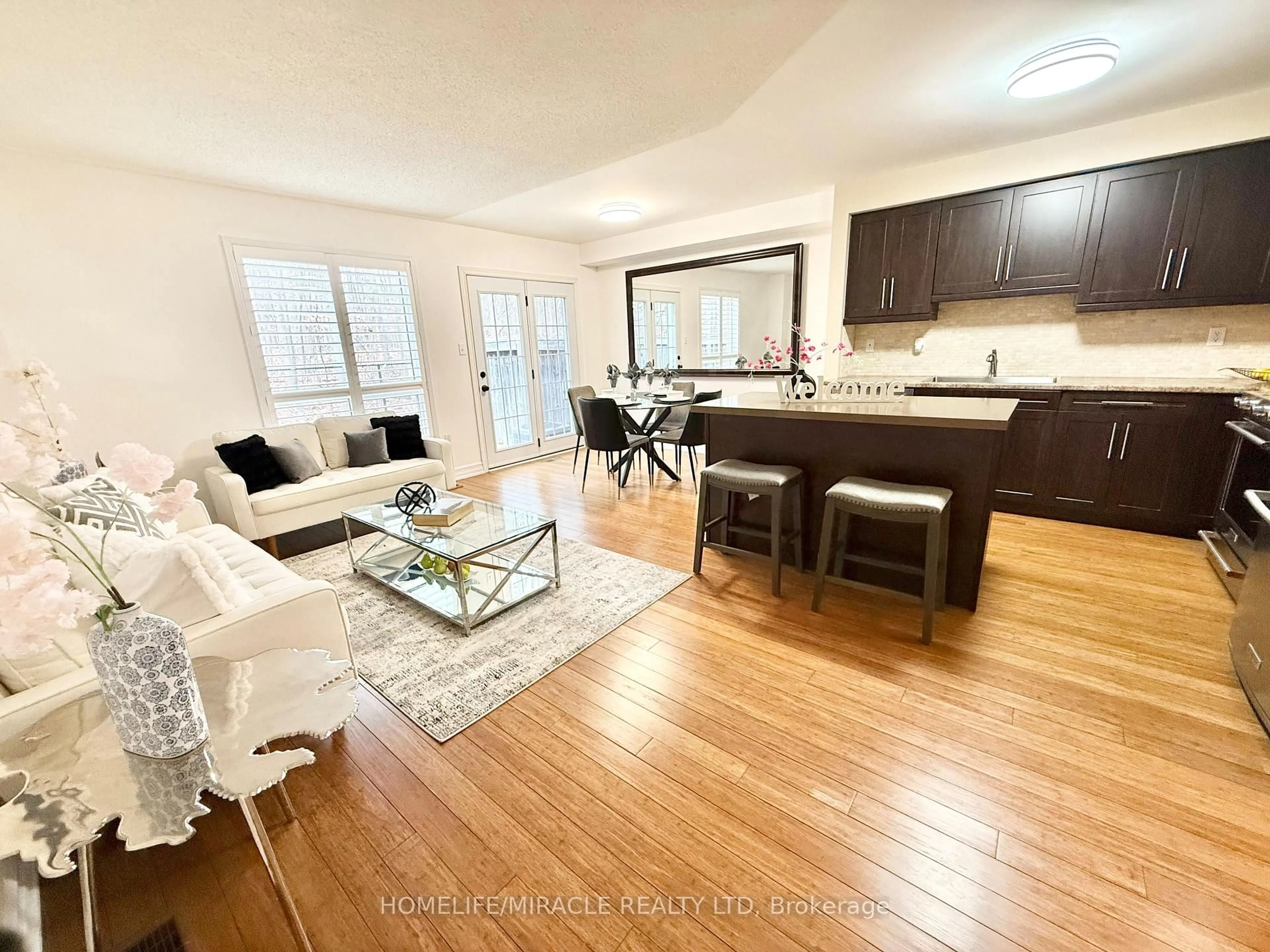 Living room with furniture, wood/laminate floor for 5530 Glen Erin Dr ##28, Mississauga Ontario L5M 6E8