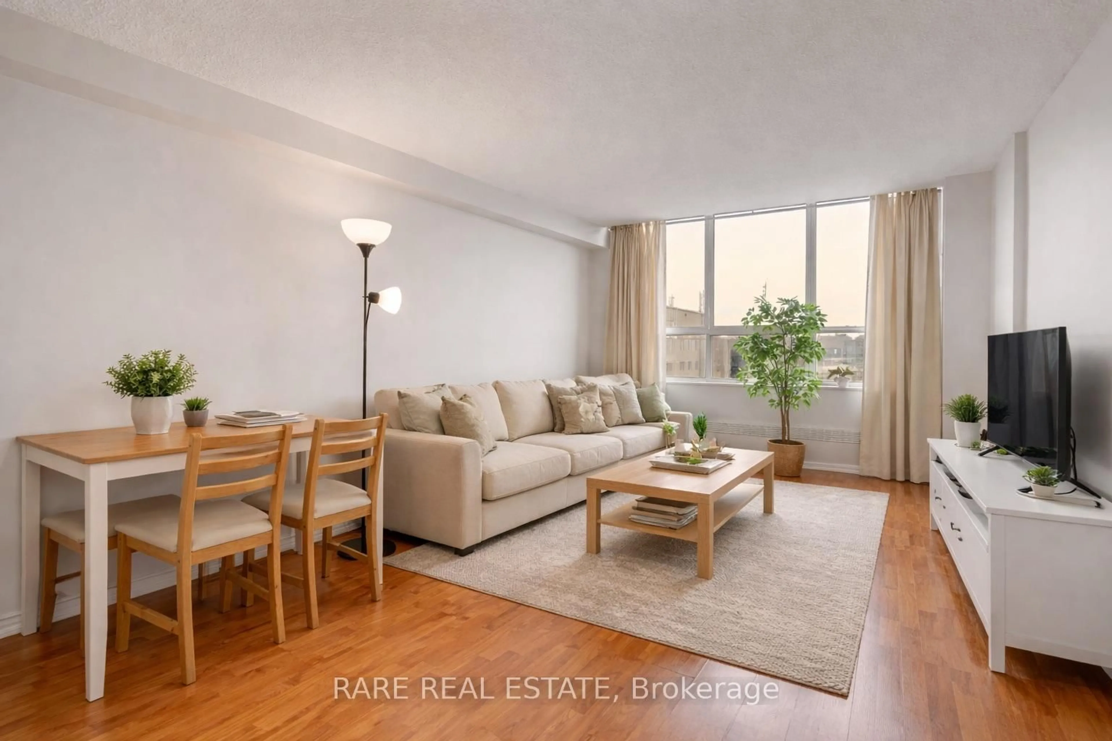 Living room with furniture, wood/laminate floor for 50 Lotherton Ptwy #1210, Toronto Ontario M6B 2G7