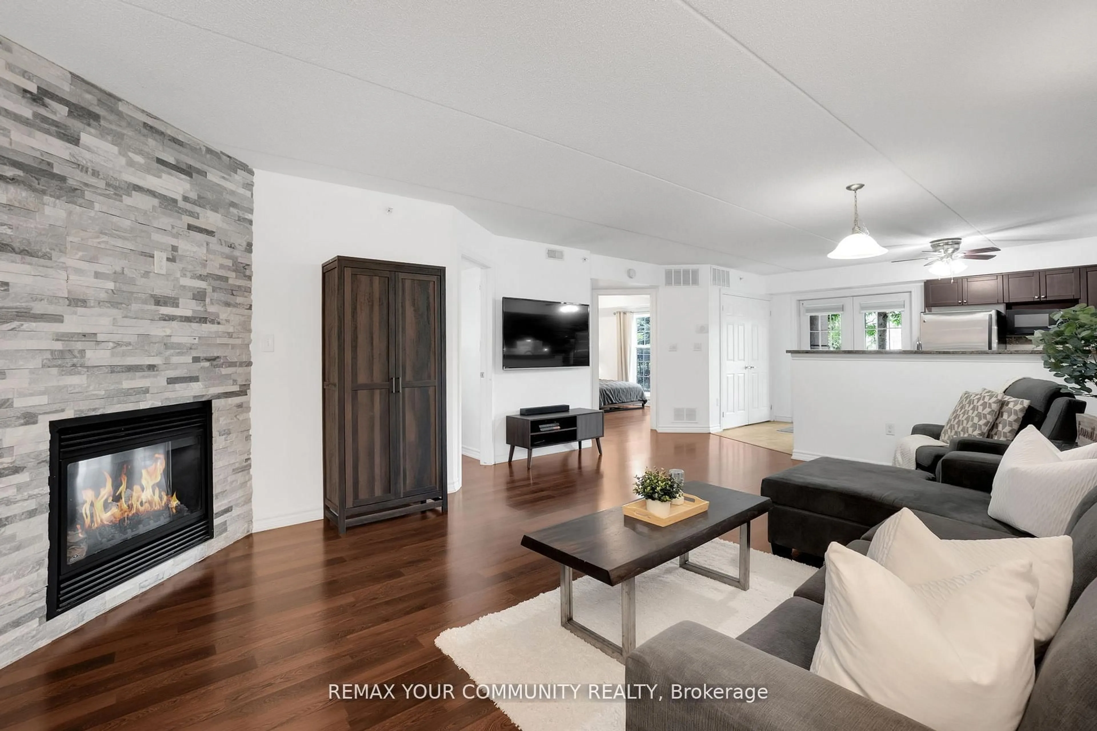 Living room with furniture, wood/laminate floor for 1360 Main St #101, Milton Ontario L9T 7S5