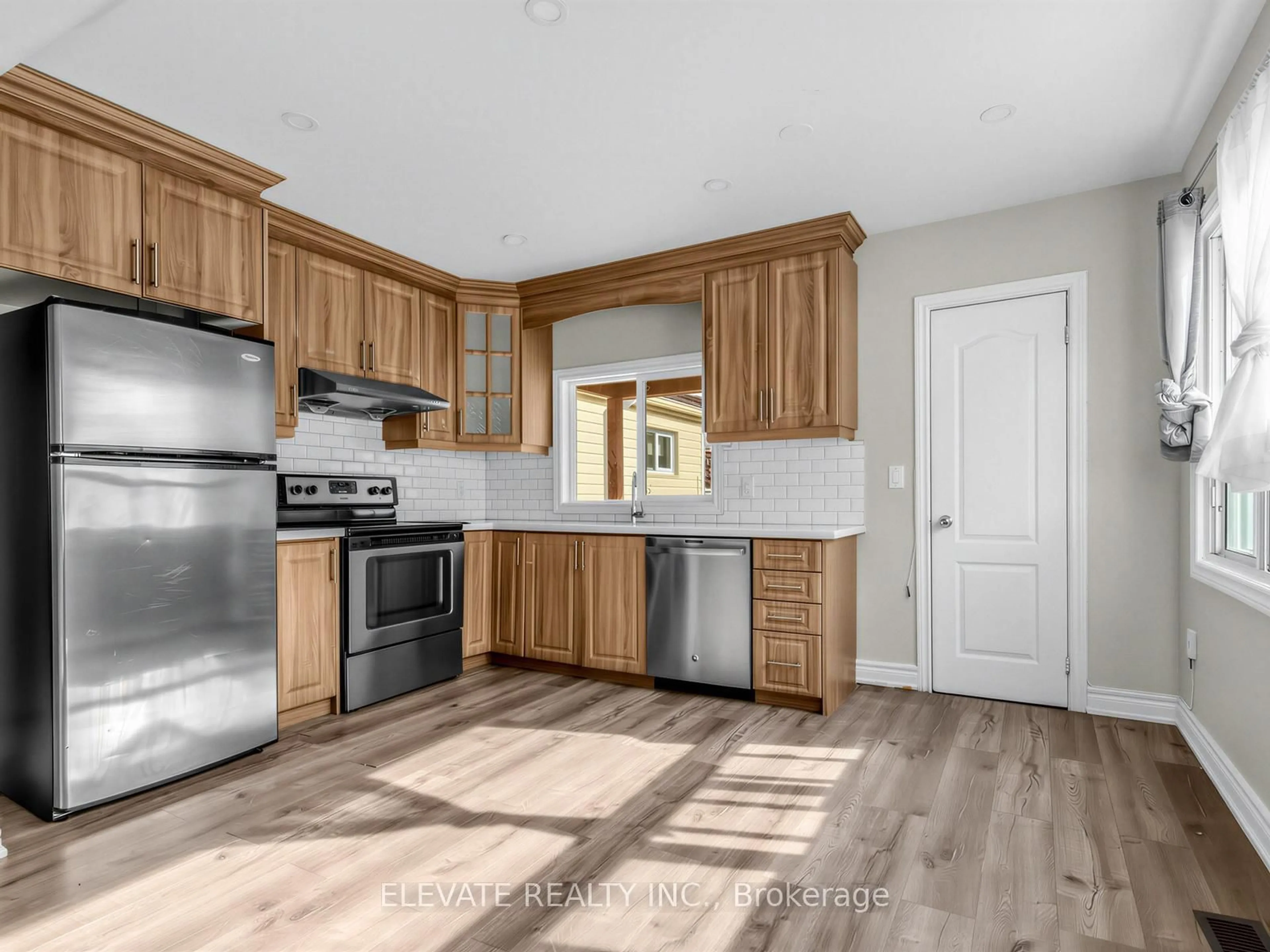 Open concept kitchen, wood/laminate floor for 11 Rowntree Ave, Toronto Ontario M6N 1R4