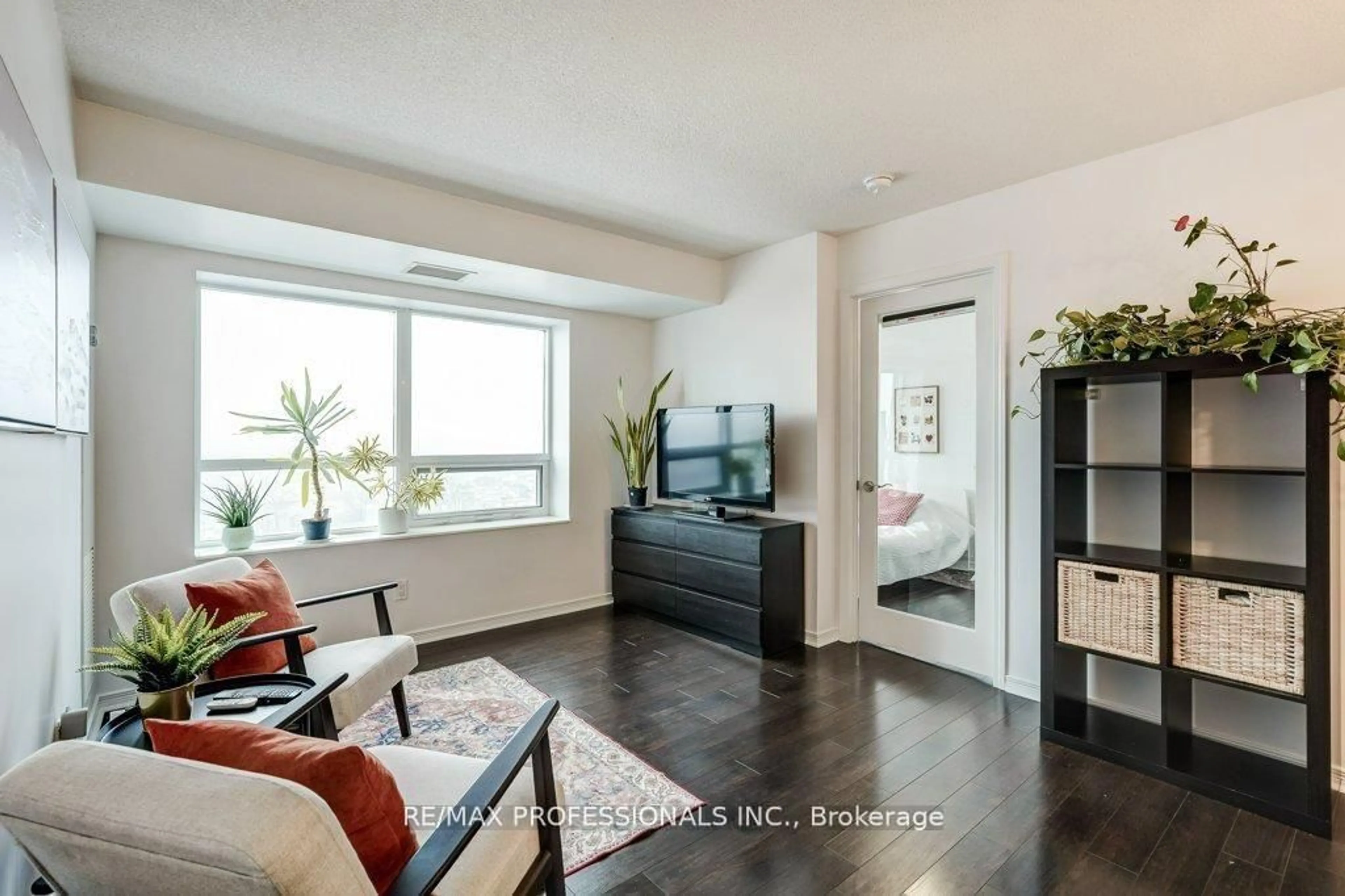 Living room with furniture, wood/laminate floor for 60 Heintzman St #930, Toronto Ontario M6P 5A1